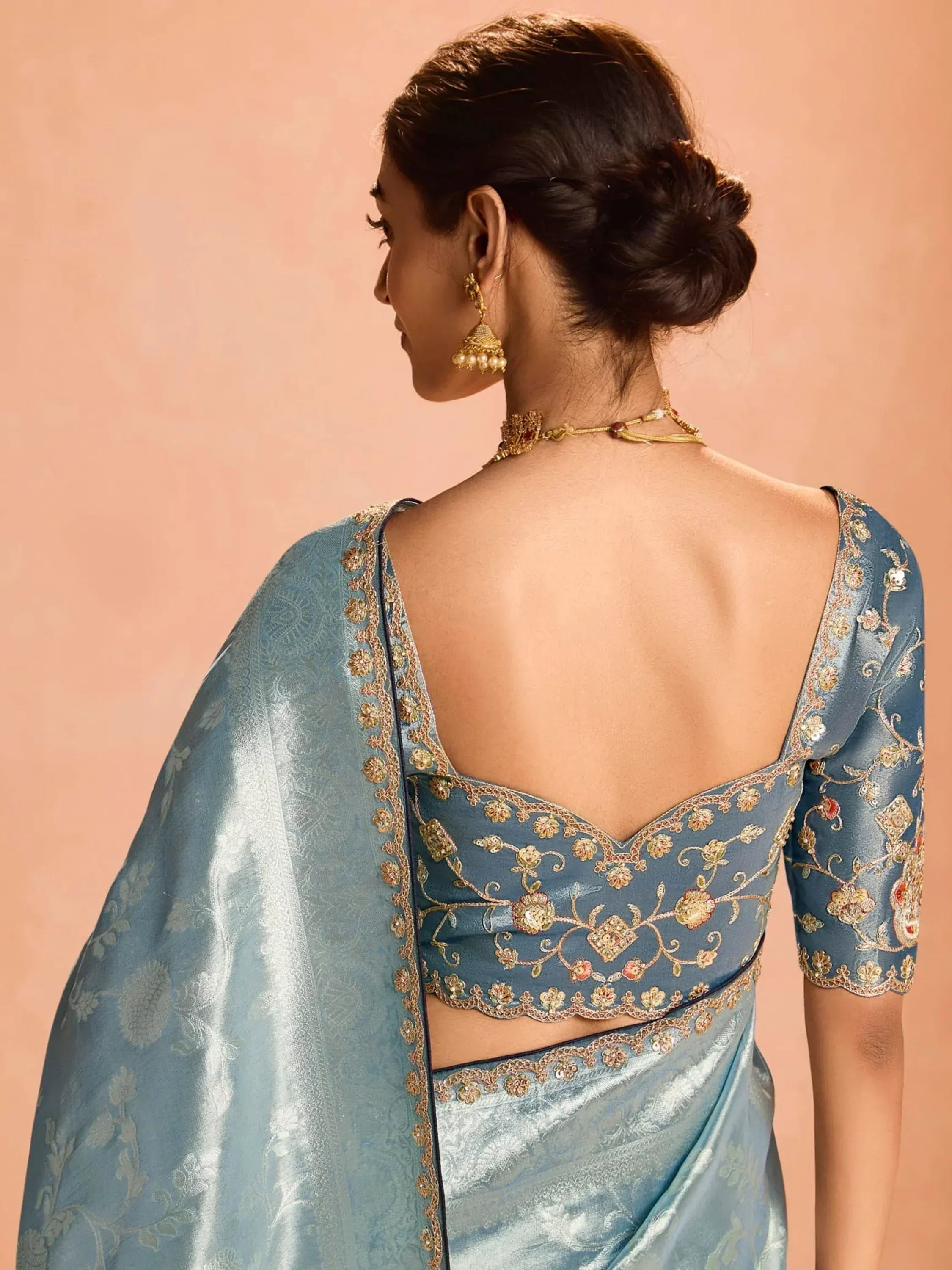 Blue embroidered saree with floral design and gold detailing, perfect for ethnic occasions.