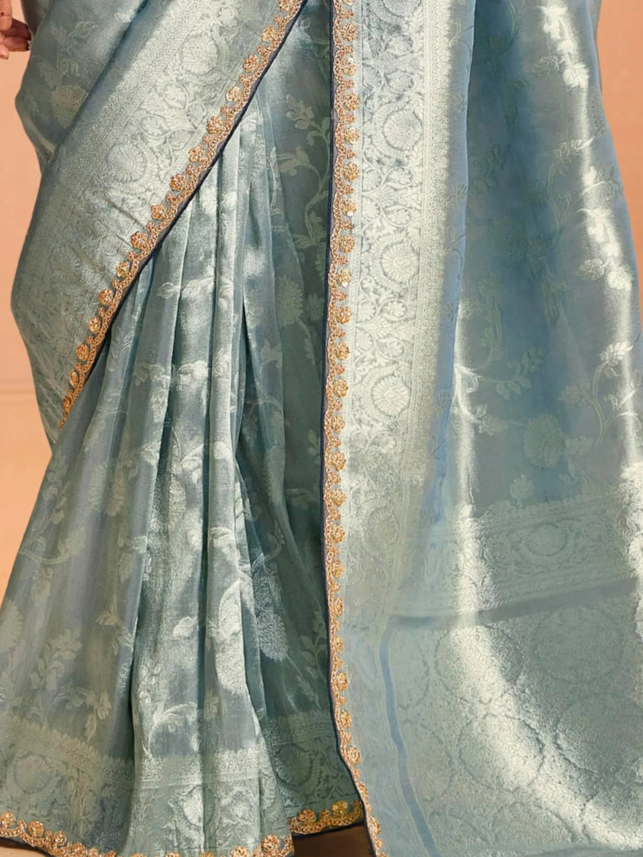 Dusty blue designer saree with gold floral embroidery and intricate border detailing
