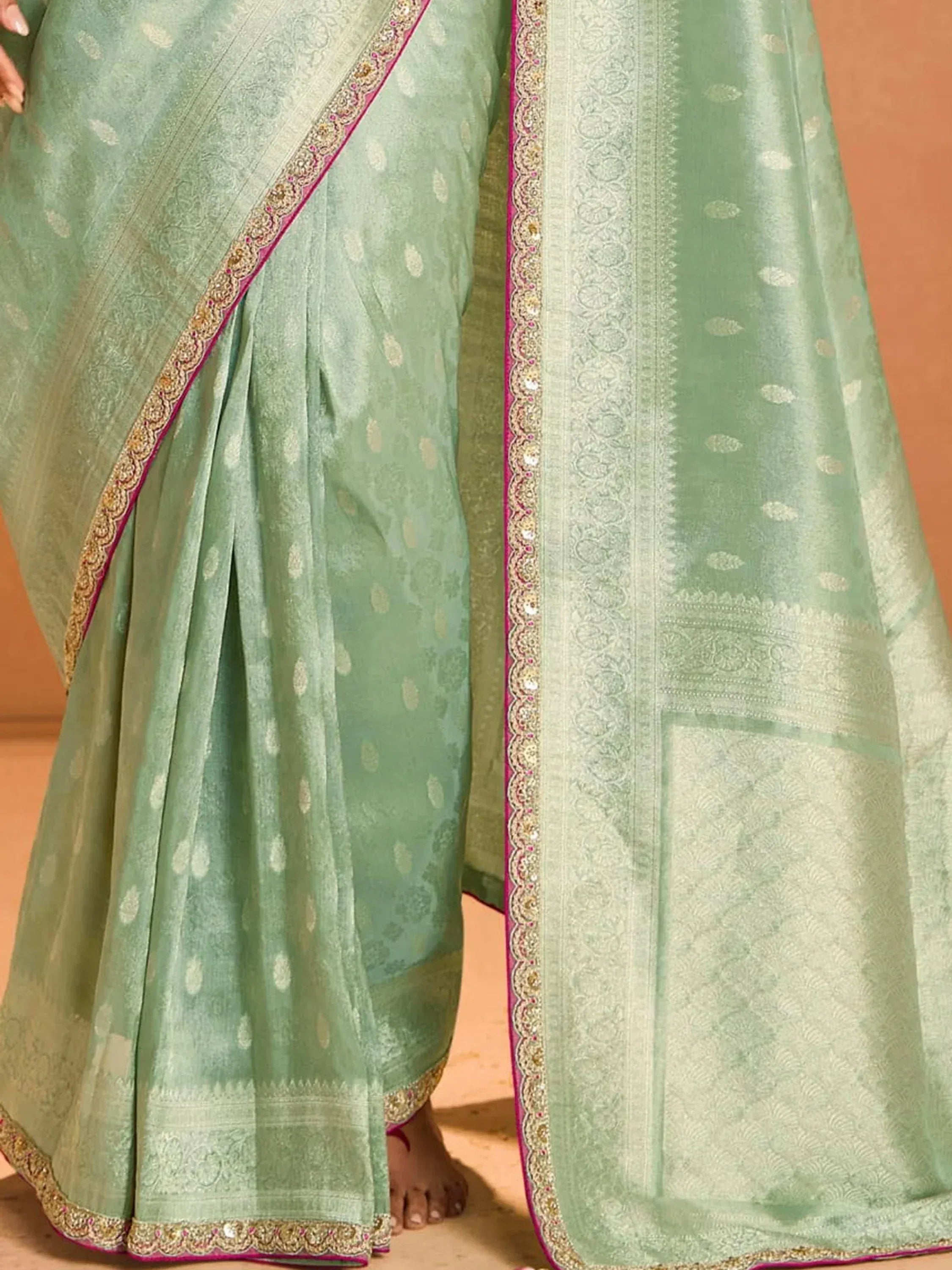 Mint green designer saree with gold paisley print and pink embroidered border, ethnic wear