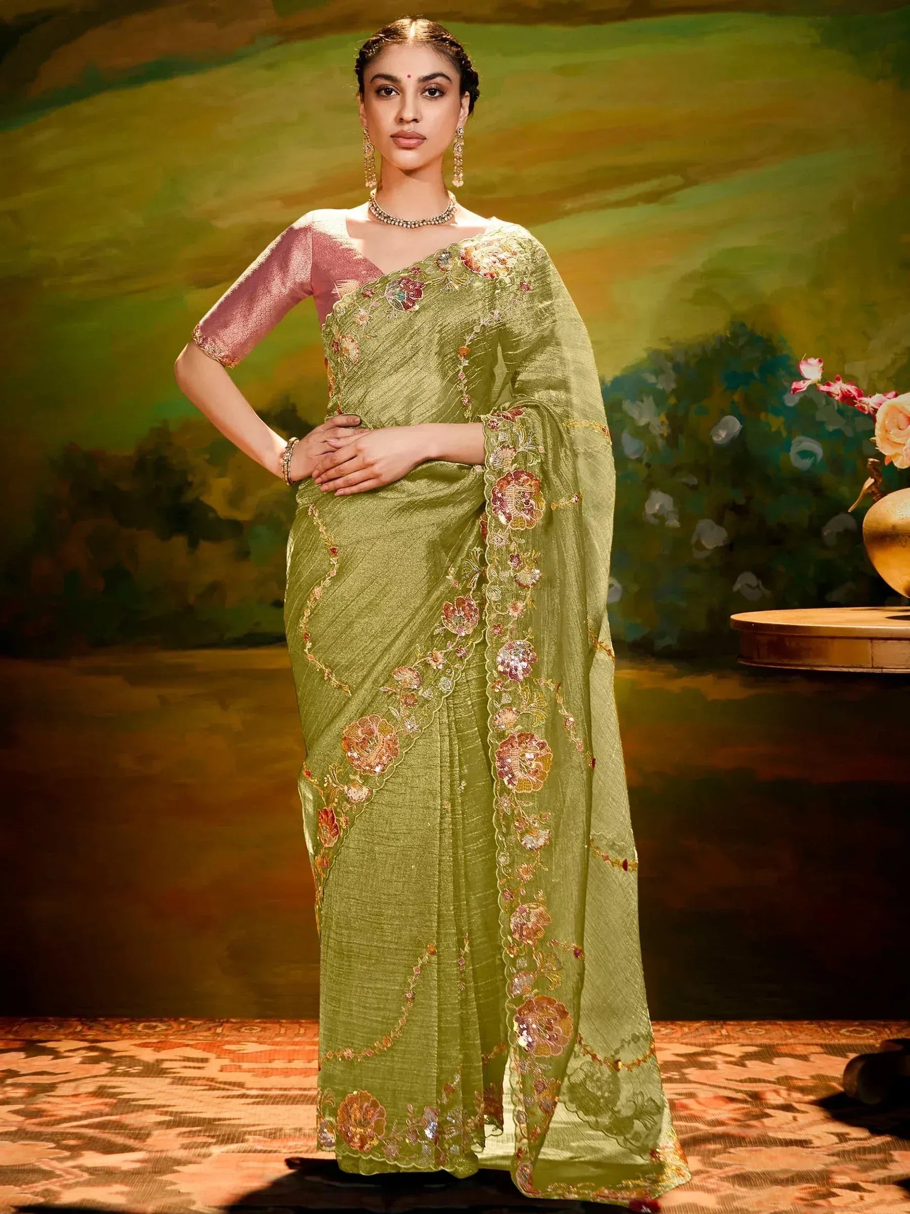 Olive green embroidered saree with floral motifs and pink blouse, perfect for Indian ethnic occasions.