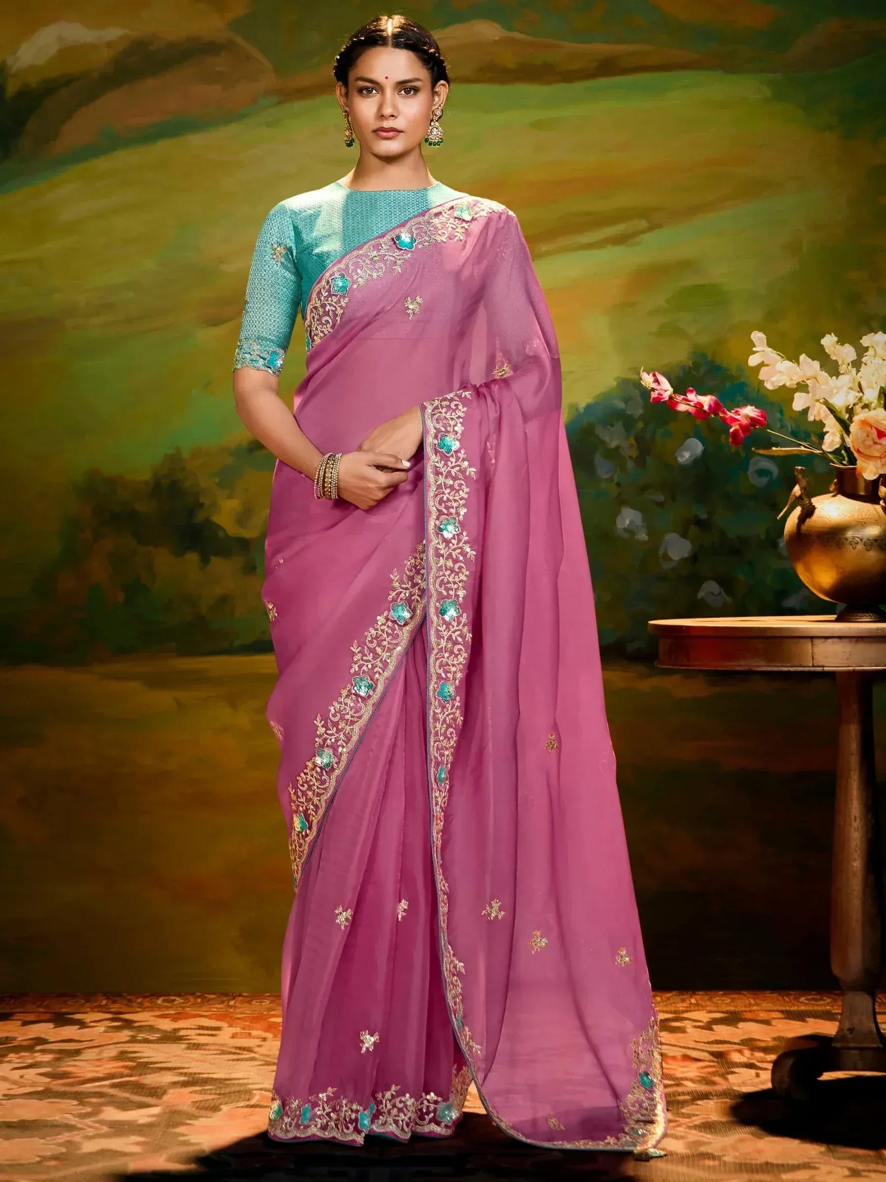 Elegant purple saree with teal blouse, gold embroidery, and floral embellishments for Indian ethnic wear