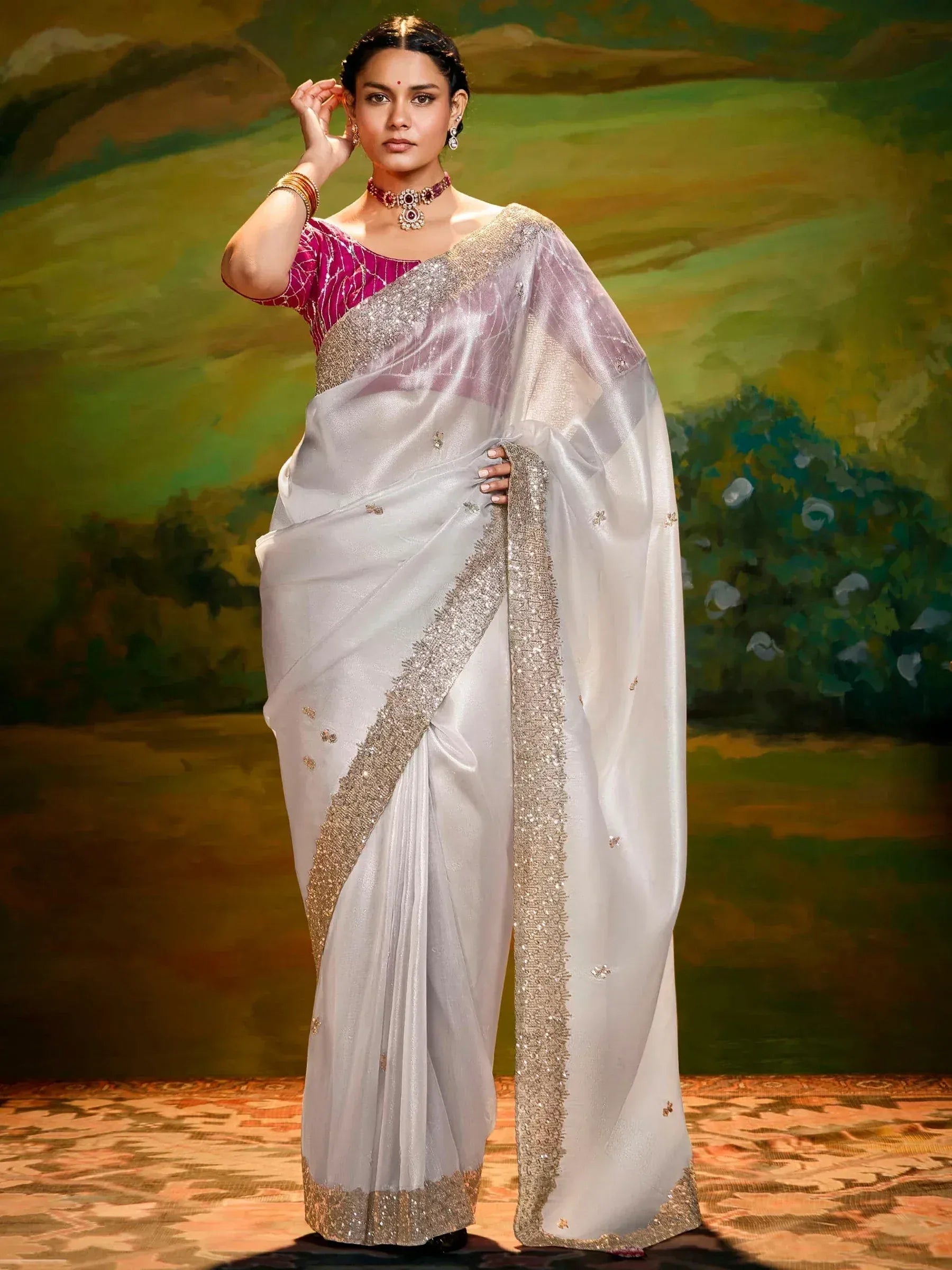 Elegant white saree with gold embroidery and pink blouse, styled with traditional jewelry for Indian ethnic wear