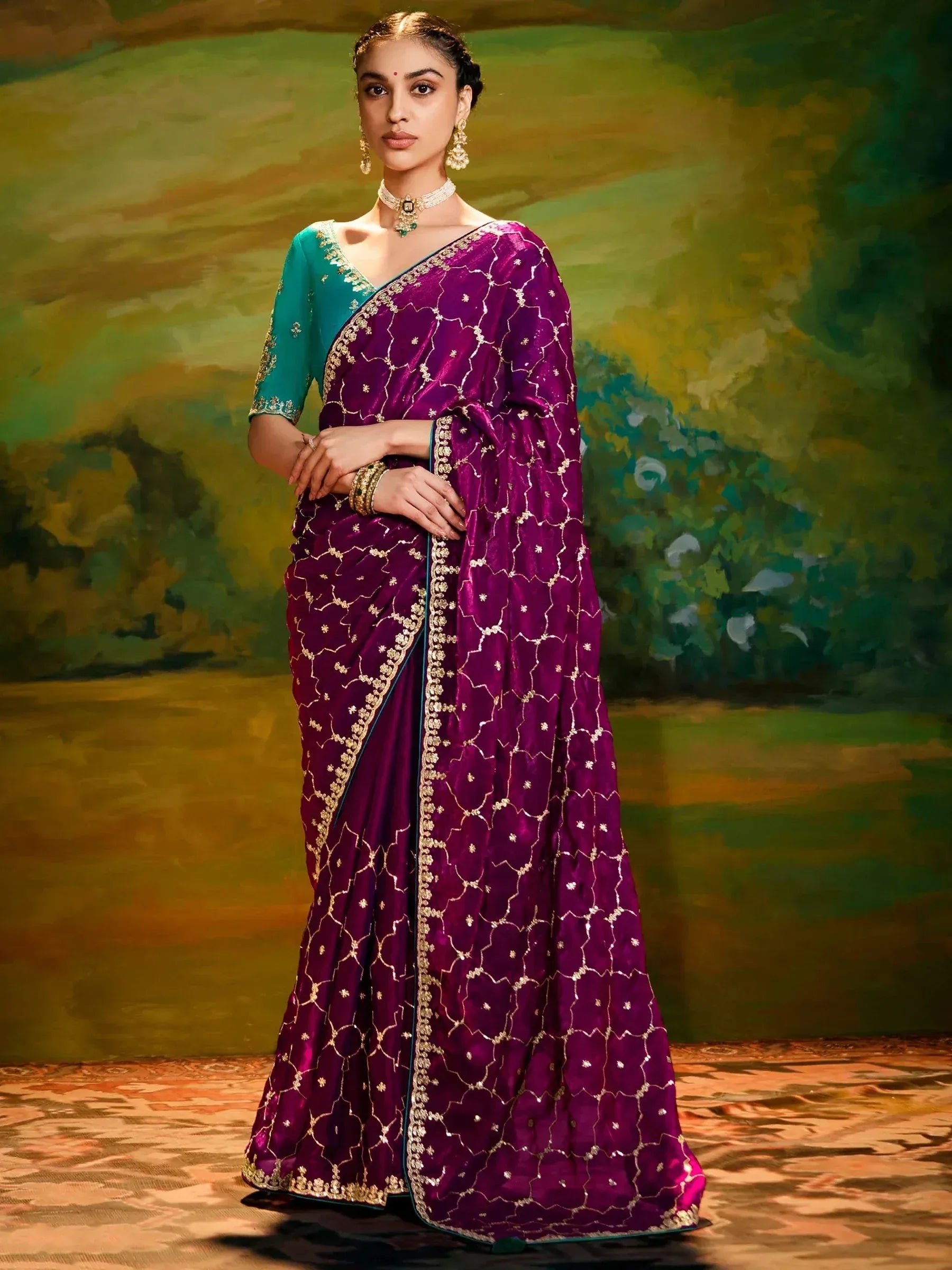 Elegant purple velvet saree with gold embroidery, paired with teal blouse, perfect for Indian ethnic occasions.