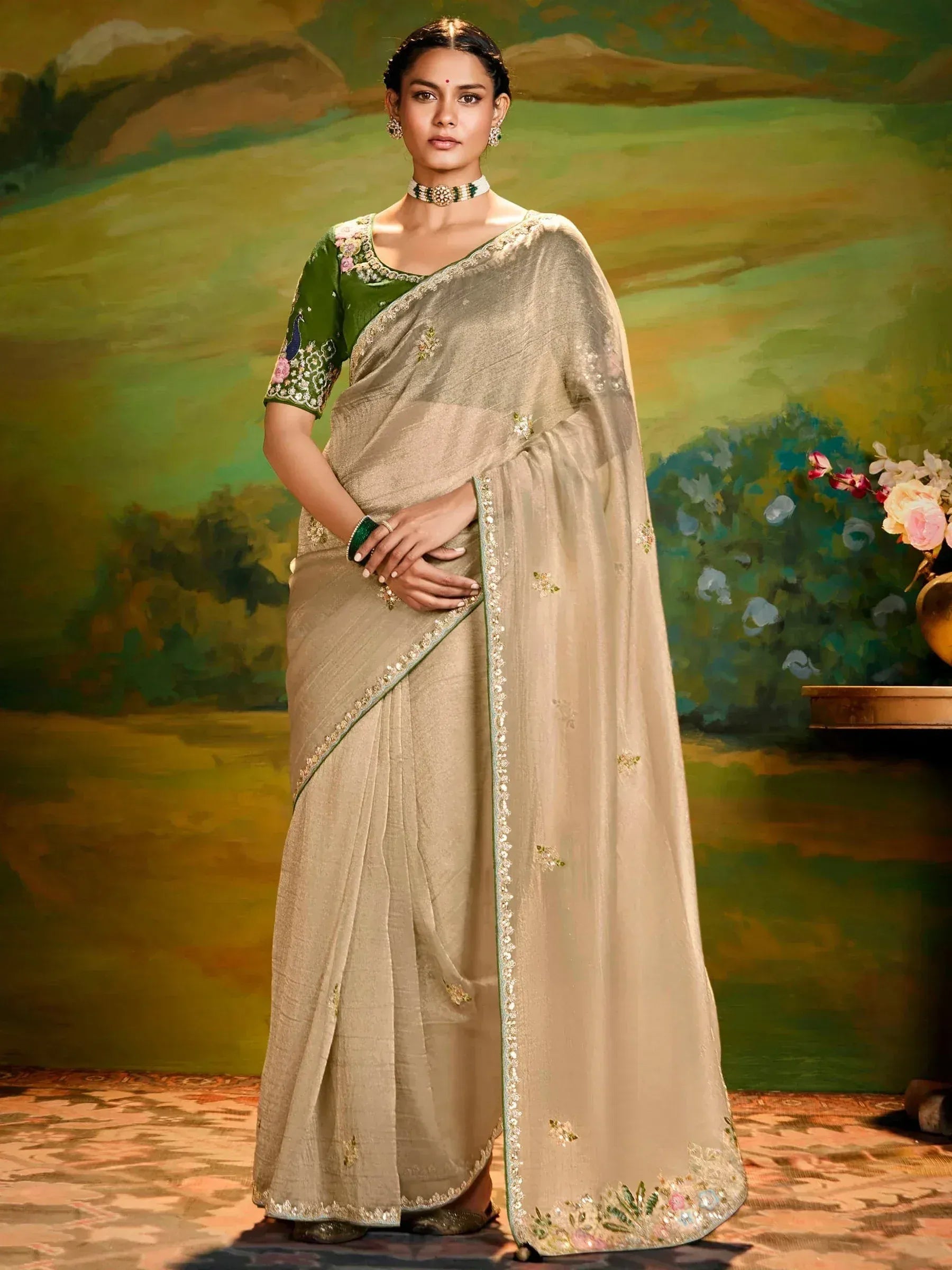Elegant beige saree with green embroidered blouse, perfect for Indian ethnic wear occasions.