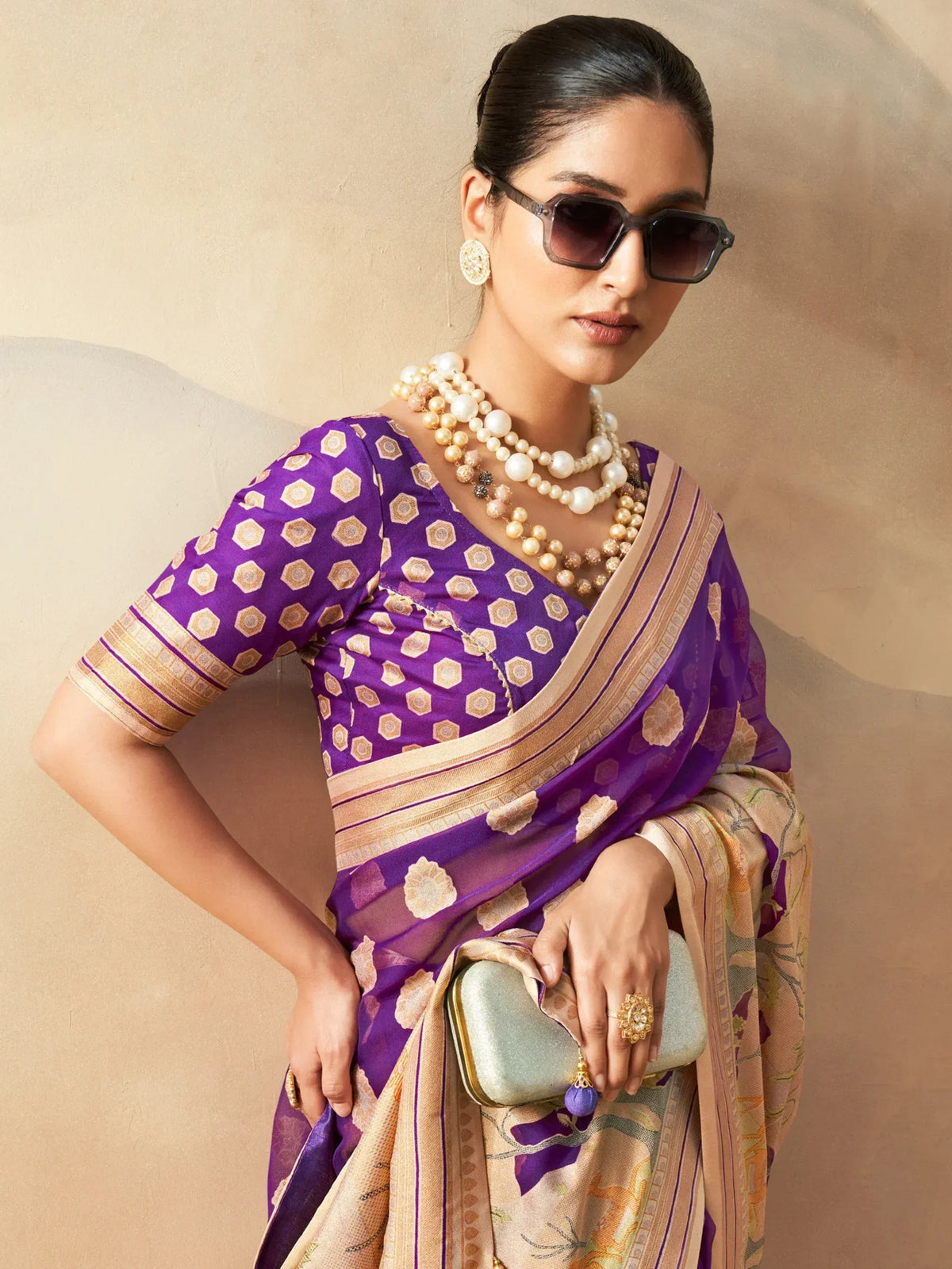 Purple printed saree with gold border, styled with pearl jewelry and sunglasses for ethnic fashion