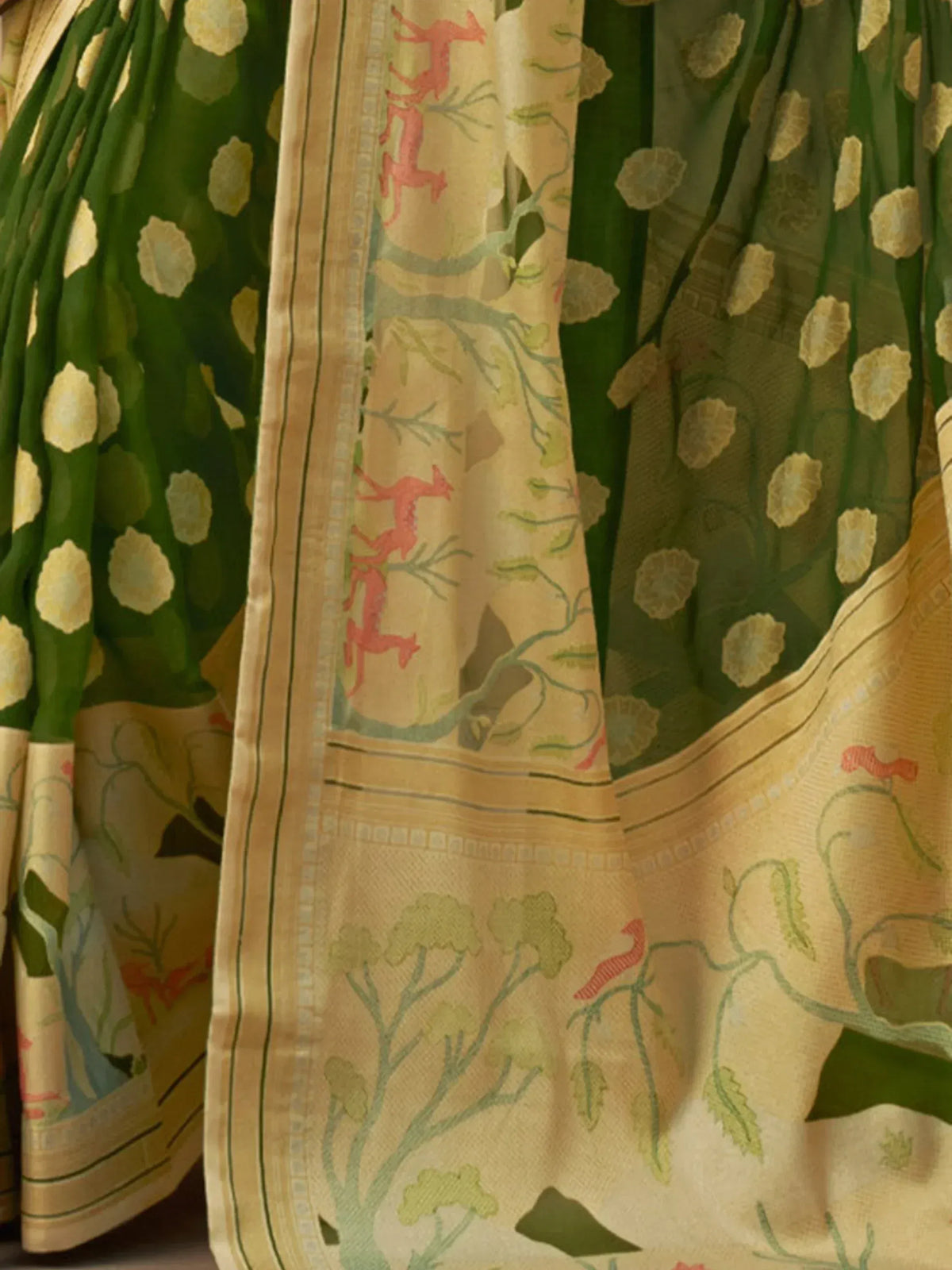 Green and gold ethnic saree with floral and deer print, perfect for Indian occasions