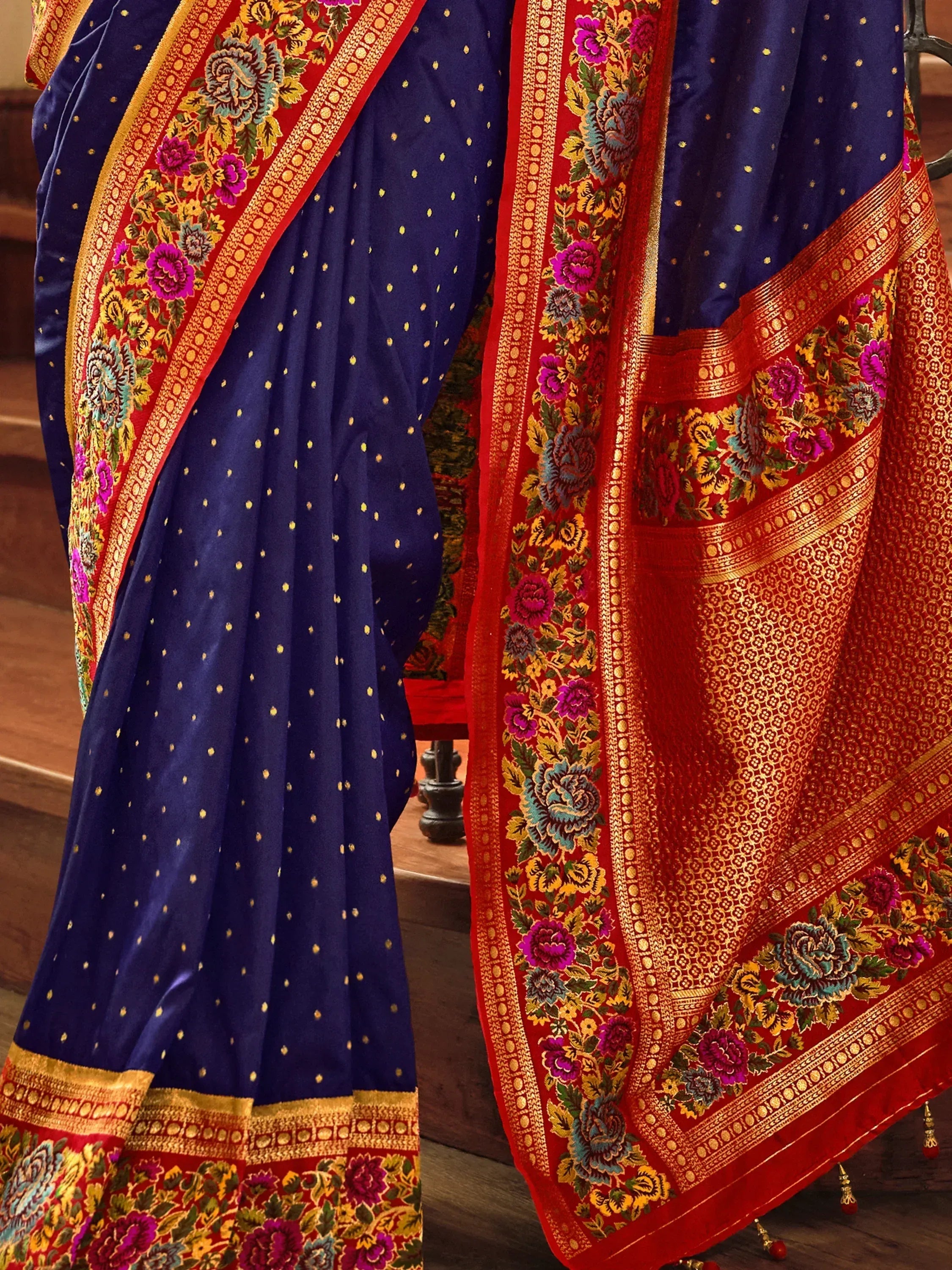 Royal blue and red Indian saree with gold floral embroidery and zari border, perfect for ethnic occasions