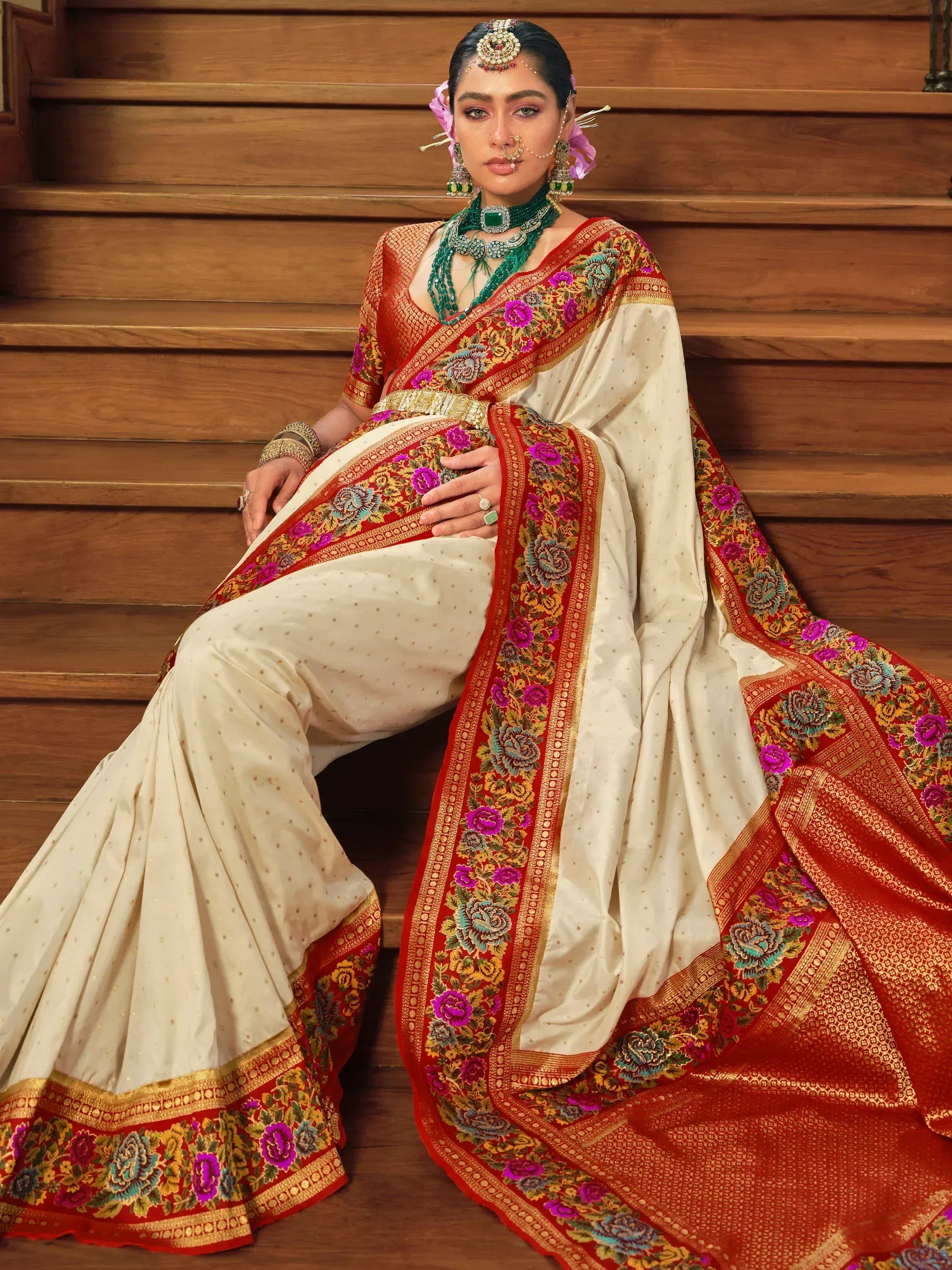 Elegant ivory saree with red floral border, traditional Indian ethnic wear for weddings and festivals