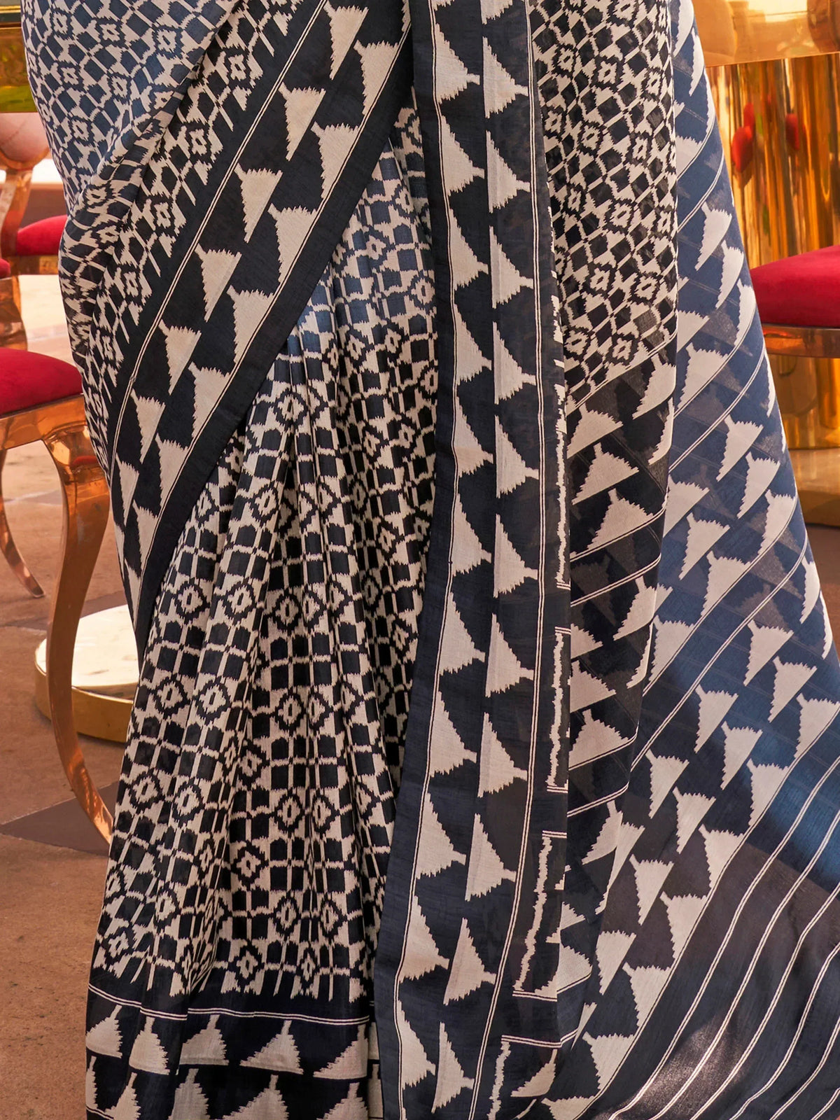 Blue and white geometric patterned ethnic saree with intricate ikat design, perfect for traditional occasions.