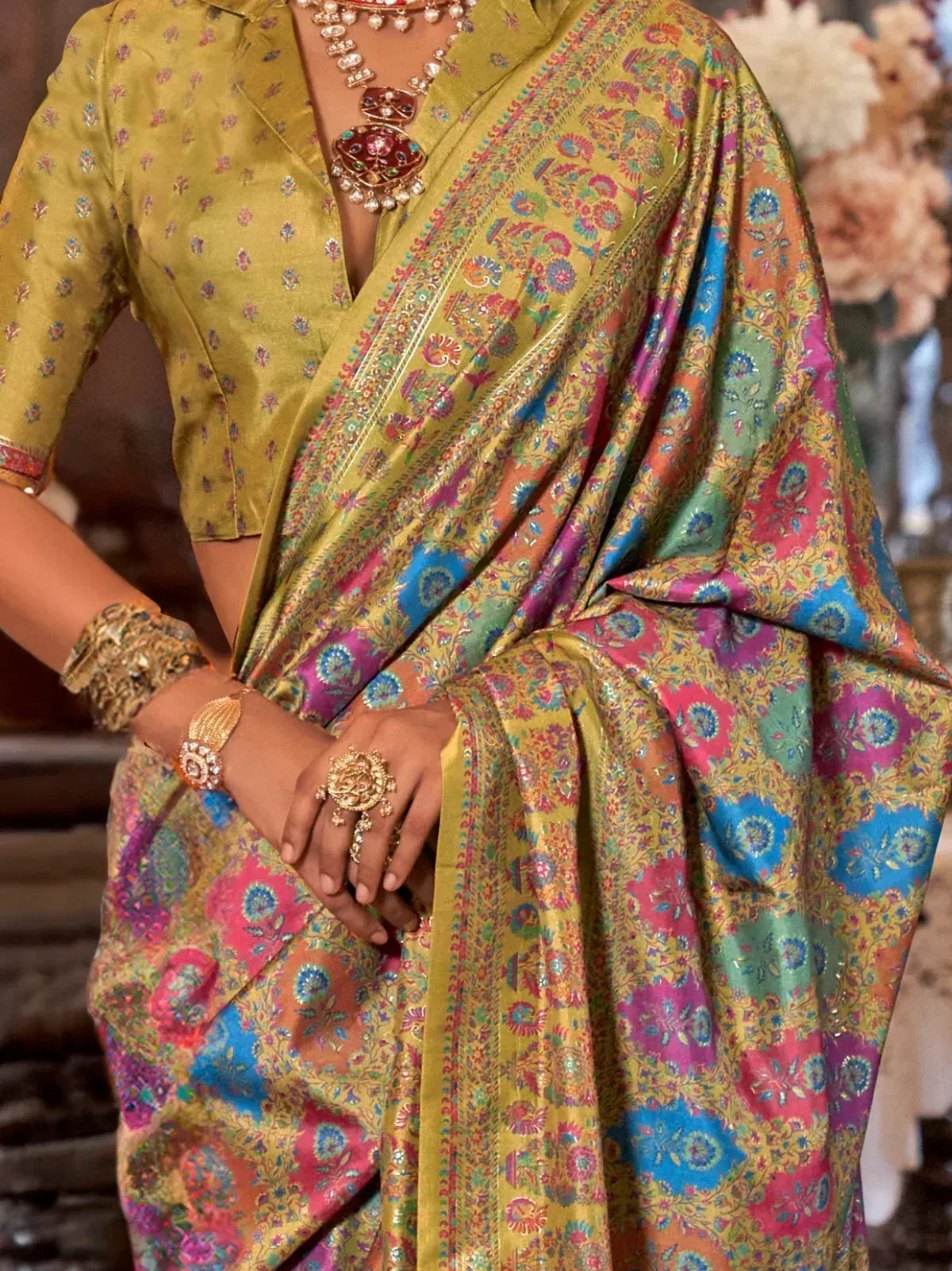 Vibrant multicolor floral saree with gold blouse, traditional Indian ethnic wear, adorned with statement jewelry