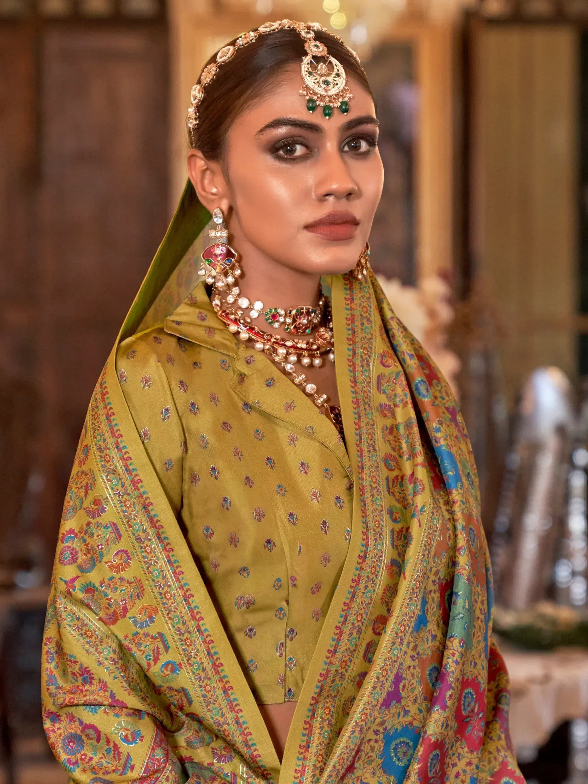 Elegant woman in mustard yellow embroidered ethnic suit with colorful dupatta and traditional jewelry