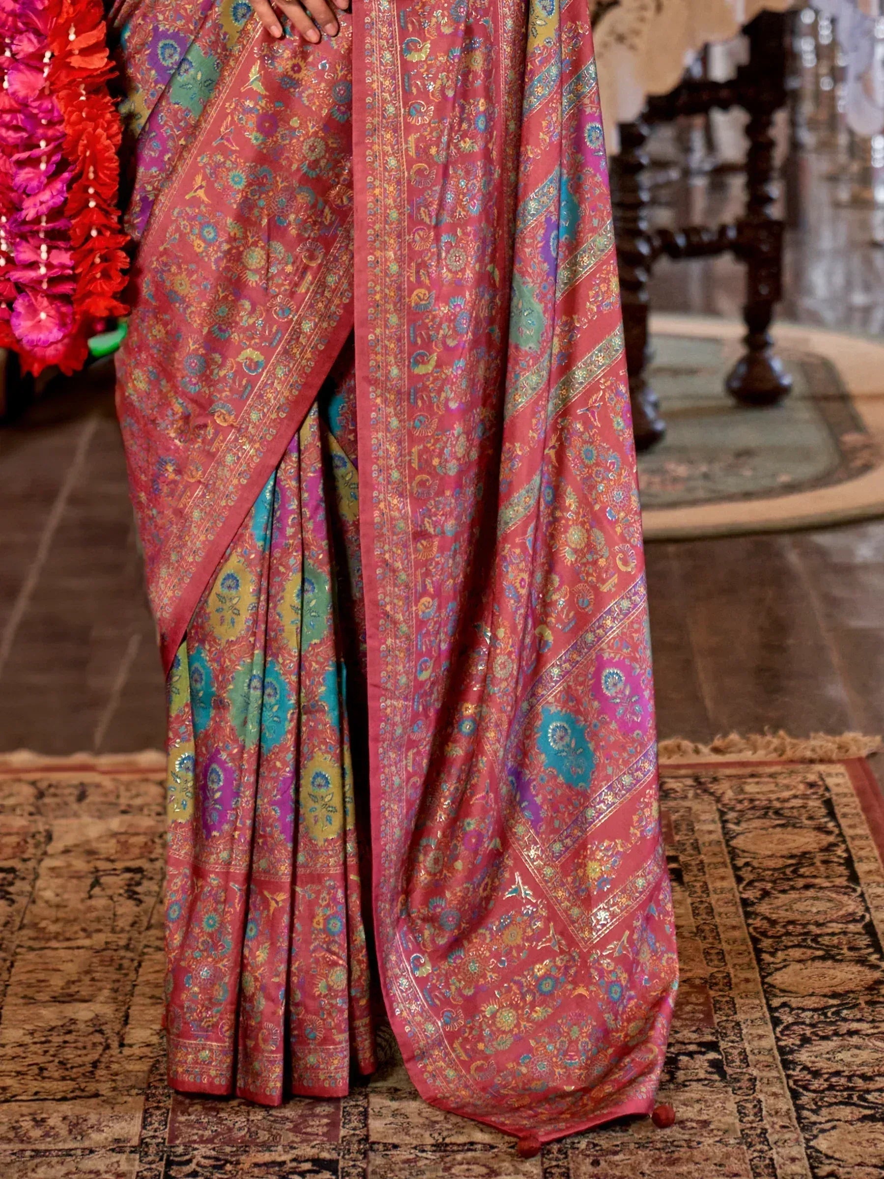 Vibrant pink saree with intricate floral and paisley patterns, perfect for Indian ethnic wear.
