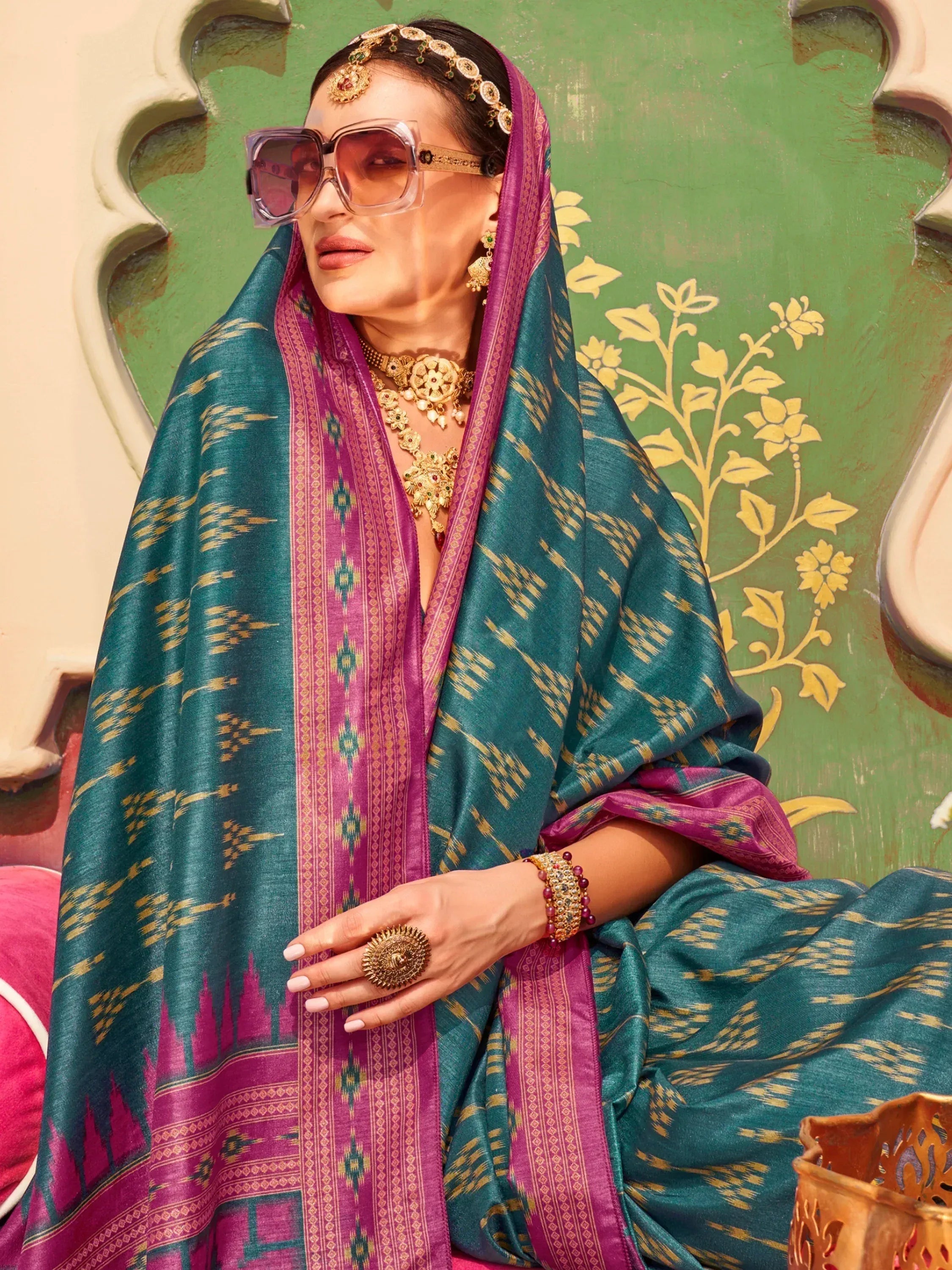 Teal and magenta ikat saree with gold jewelry, styled for Indian ethnic wear