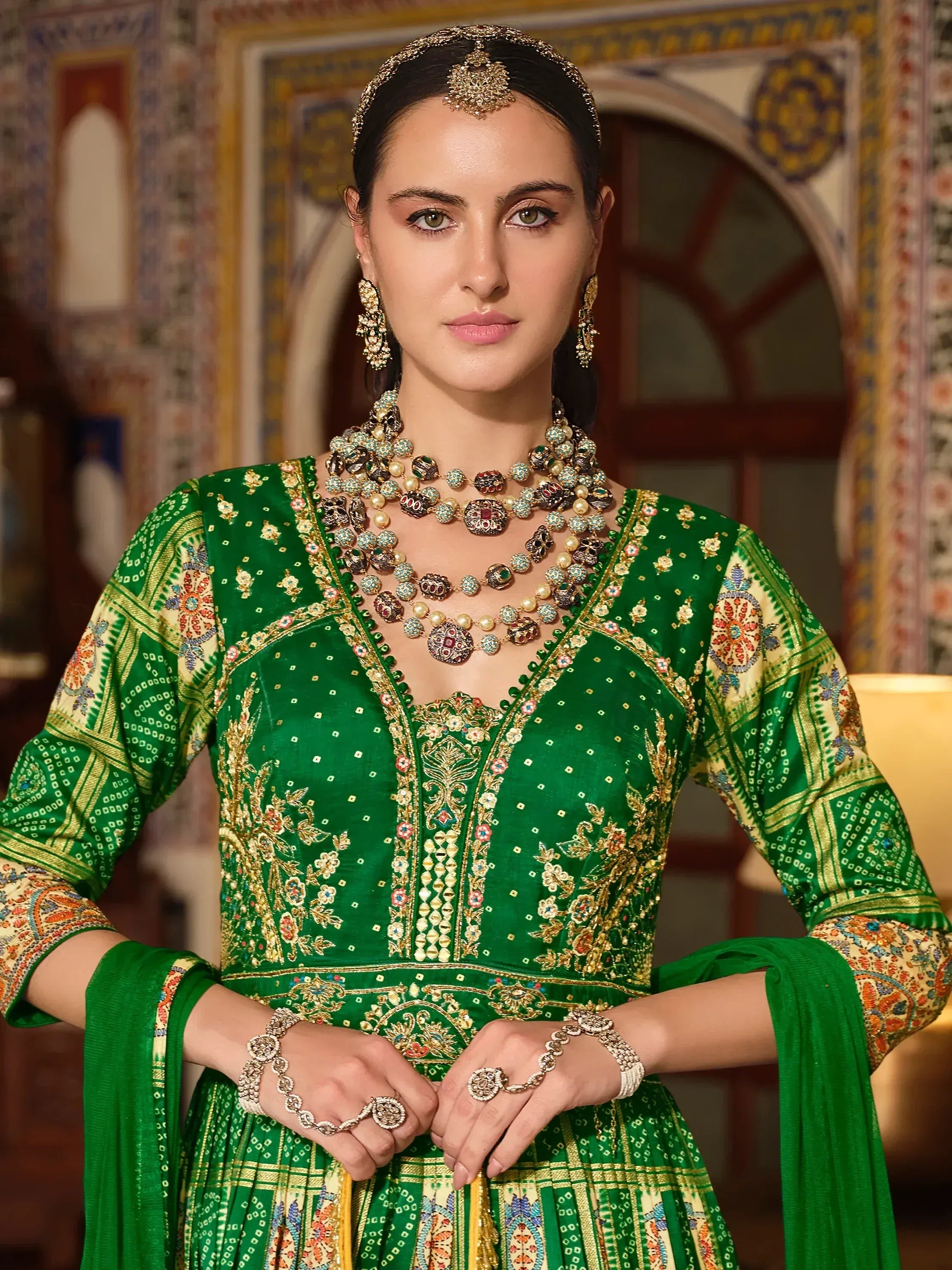 Emerald green embroidered lehenga choli with gold detailing, traditional Indian ethnic wear for weddings