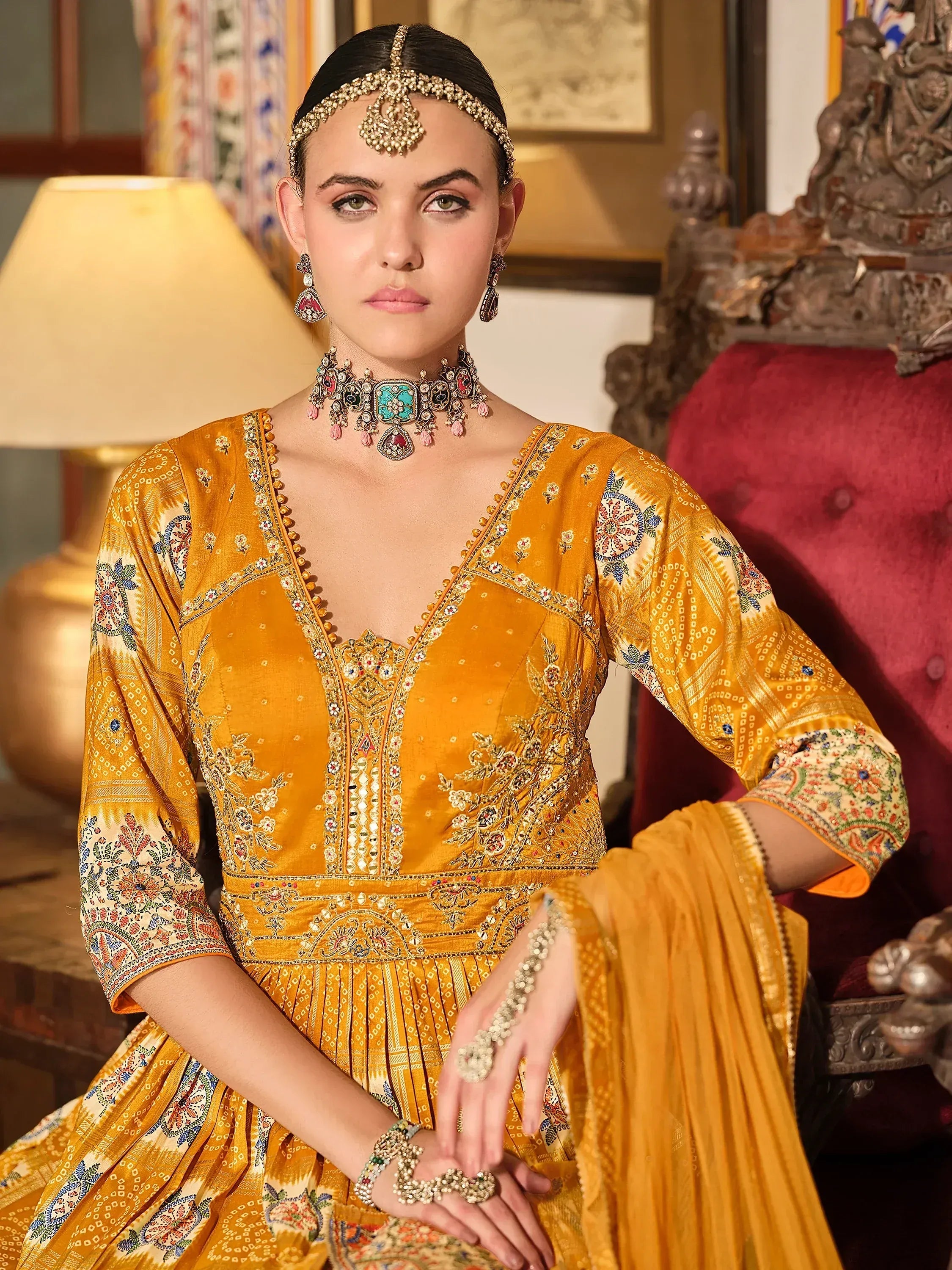 Elegant mustard yellow embroidered salwar kameez with traditional jewelry, perfect for Indian ethnic occasions.
