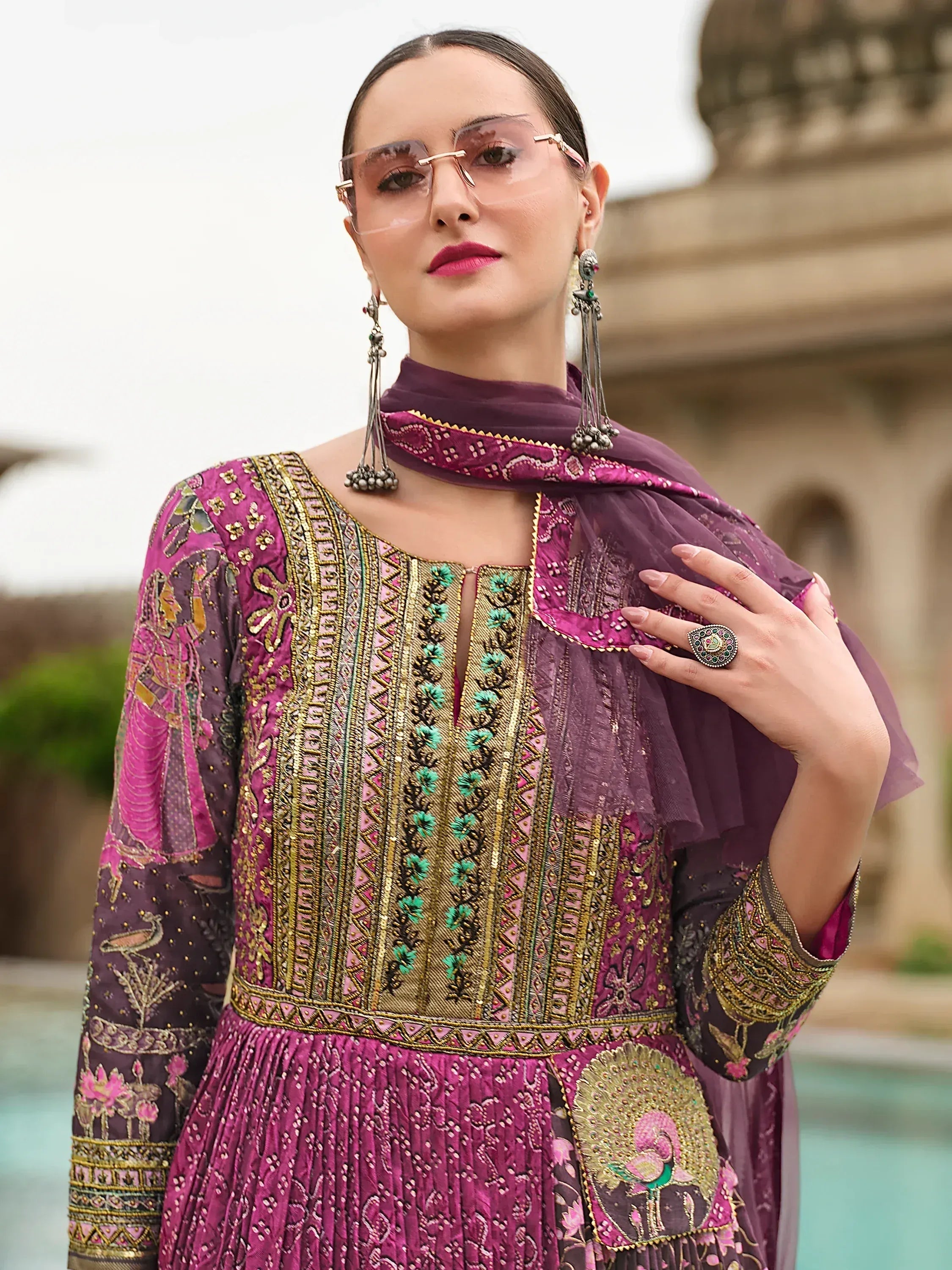 Elegant purple and pink embroidered Indian ethnic gown with gold detailing, perfect for festive occasions.