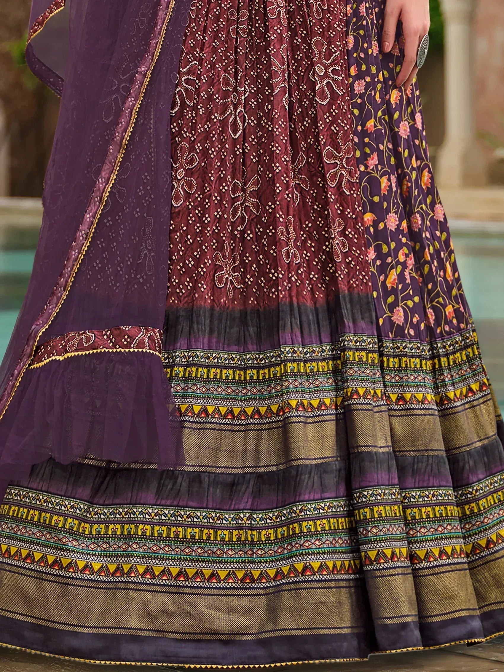 Purple and maroon floral printed ethnic lehenga with intricate borders and sheer dupatta