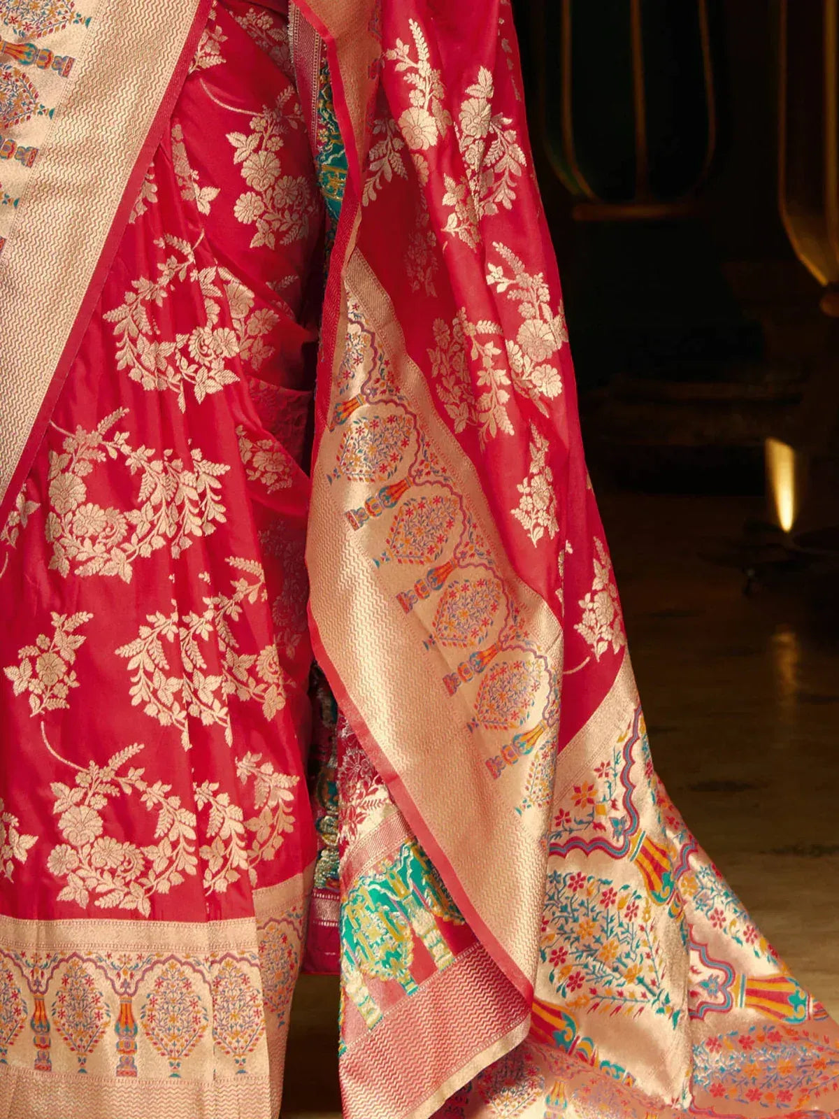 Red floral embroidered saree with intricate gold zari border and colorful pallu design