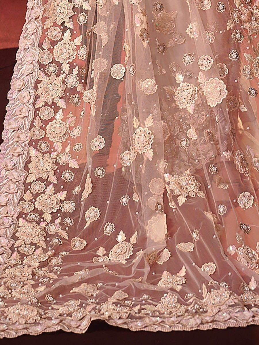 Elegant blush pink lehenga with floral lace and bead embroidery, perfect for Indian weddings and festive occasions.