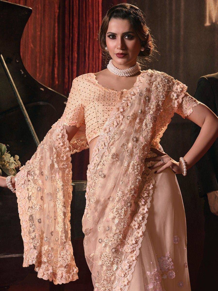 Elegant peach designer lehenga choli with floral embroidery and sheer sleeves, perfect for weddings