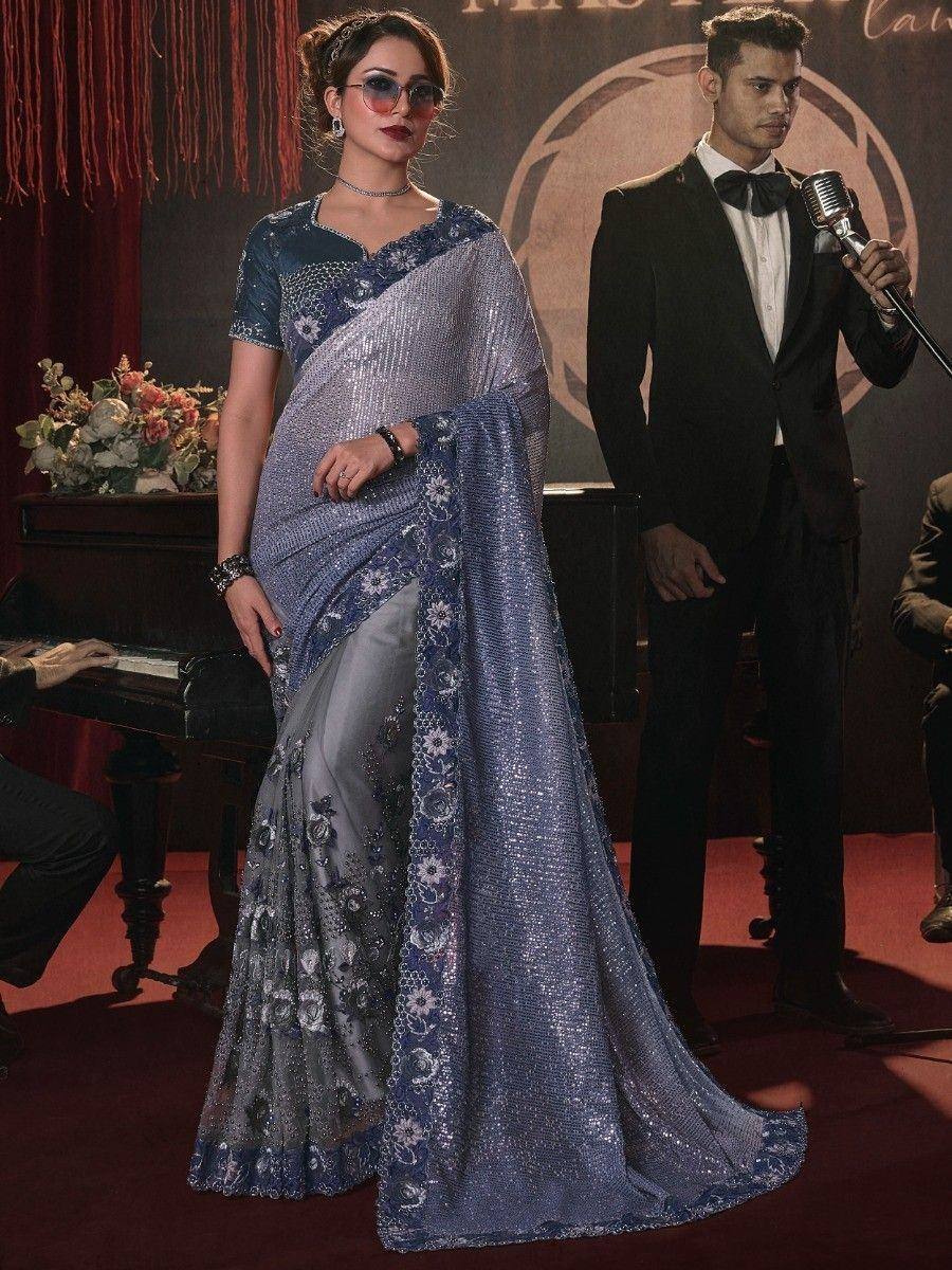 Blue sequin saree with floral embroidery, styled for evening events, paired with sunglasses and choker.