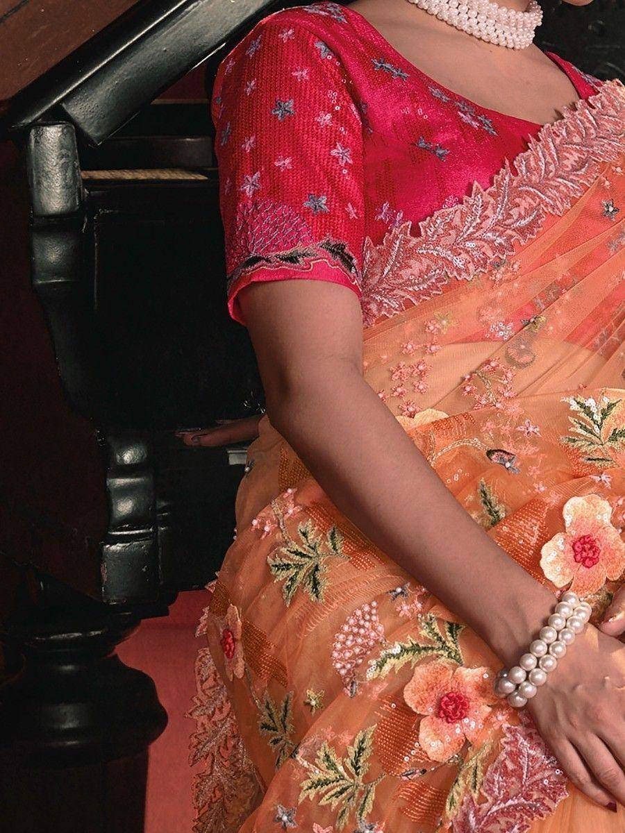Orange floral embroidered saree with pink blouse, pearl jewelry, ethnic Indian wear