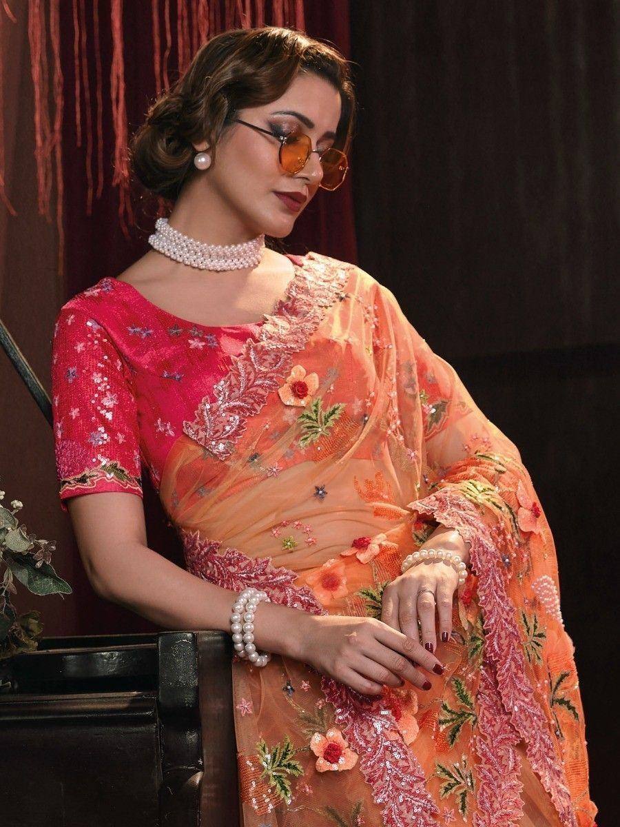 Elegant orange floral saree with pink blouse, pearl jewelry, and sunglasses for Indian ethnic wear
