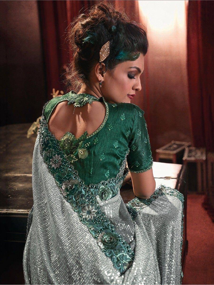 Elegant green and silver designer saree with floral embroidery and backless blouse, perfect for Indian ethnic occasions.