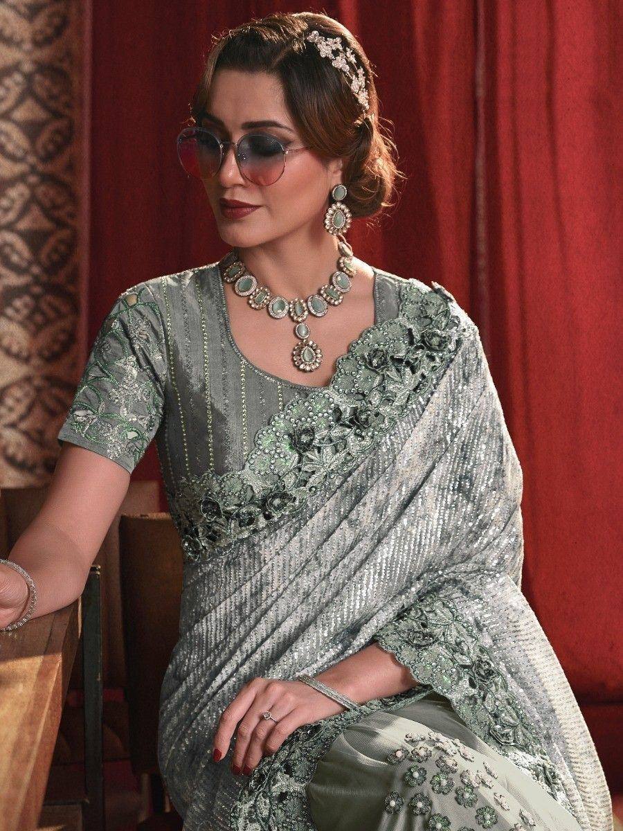Elegant green embroidered saree with sequins, floral detailing, and matching jewelry for Indian ethnic wear