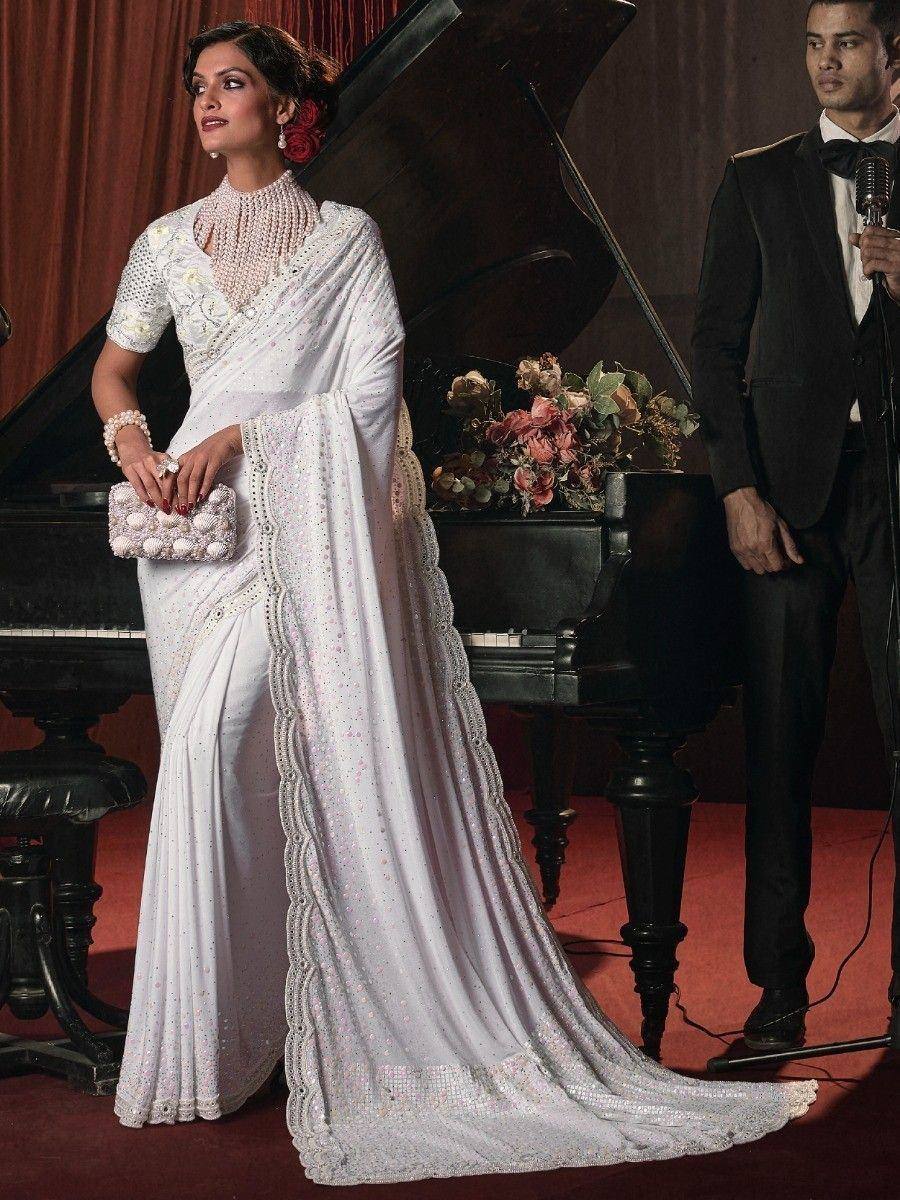 Elegant white designer saree with intricate embroidery and pearl jewelry, perfect for weddings and festive occasions.