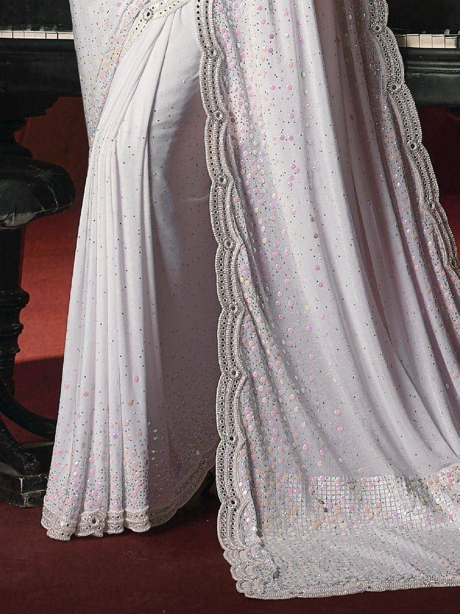 Elegant white saree with pink sequins and scalloped lace border, perfect for Indian ethnic wear occasions.