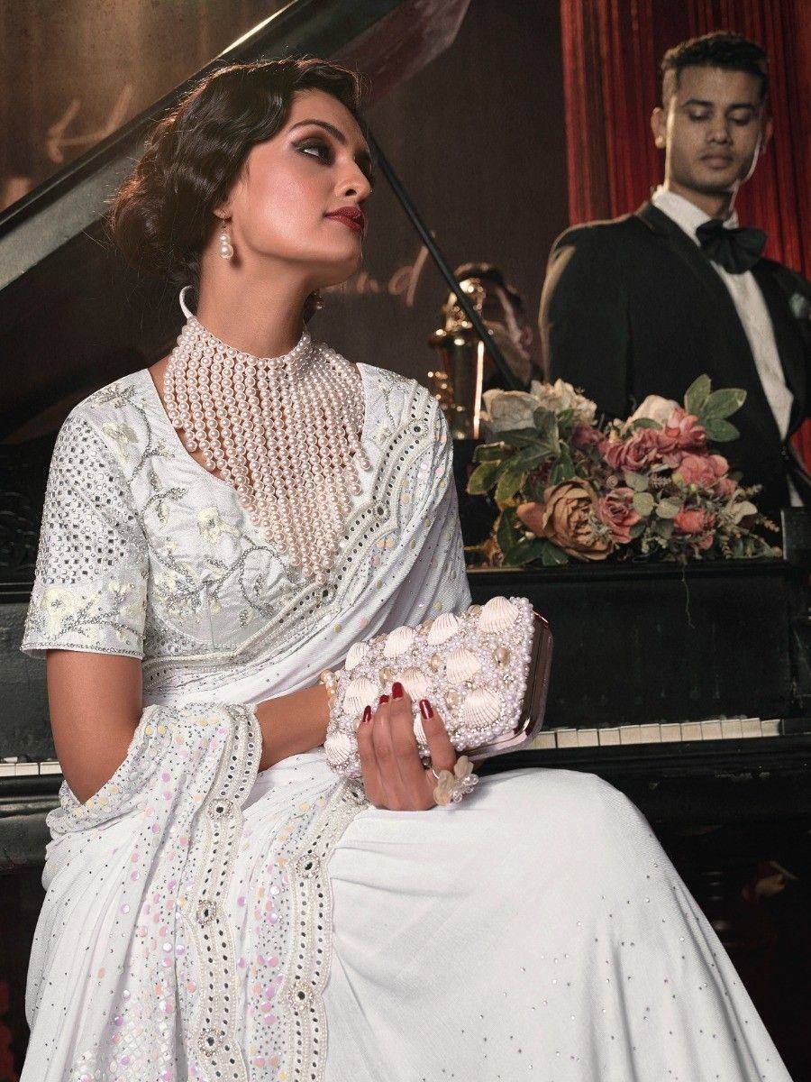 Elegant white embroidered saree with pearl jewelry, perfect for Indian ethnic events and weddings