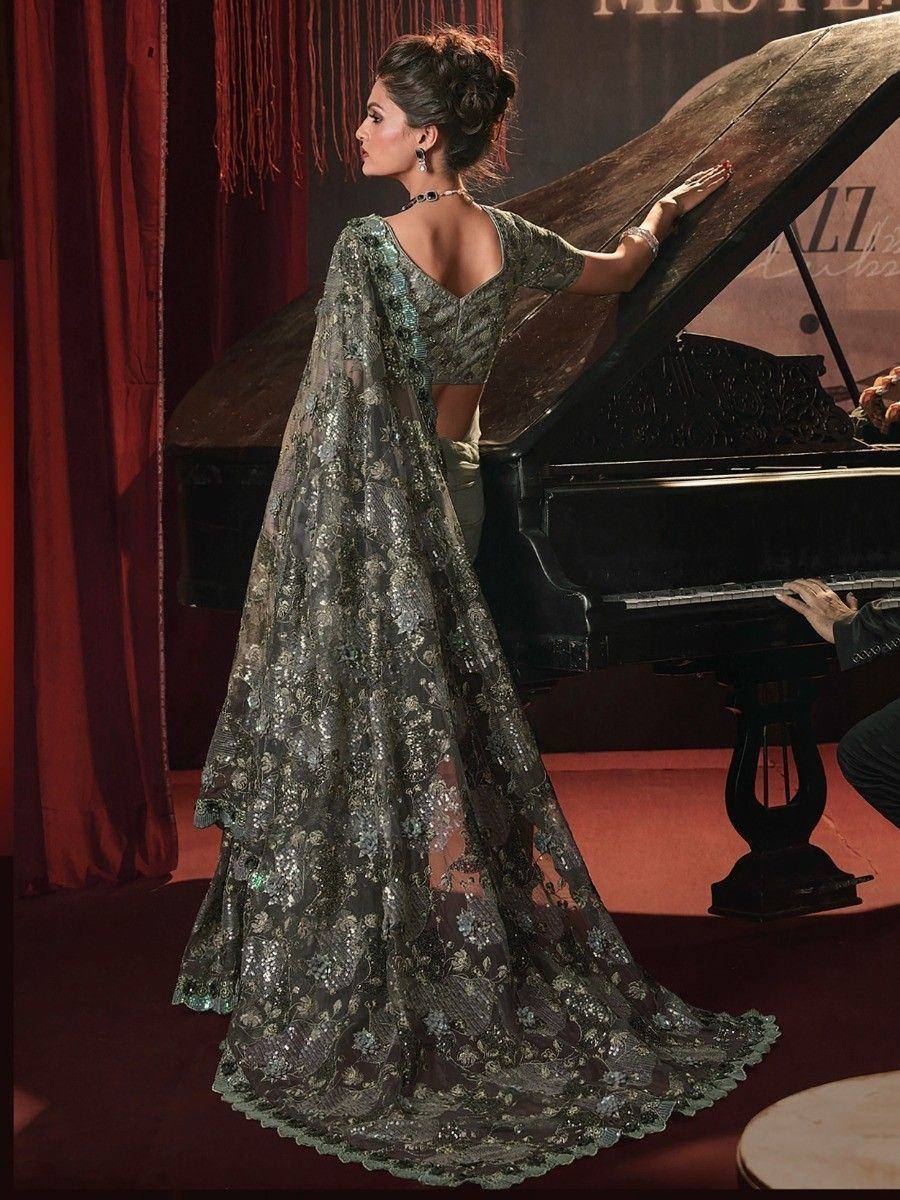 Elegant Indian ethnic gown with floral embroidery, worn by woman beside grand piano in luxury setting
