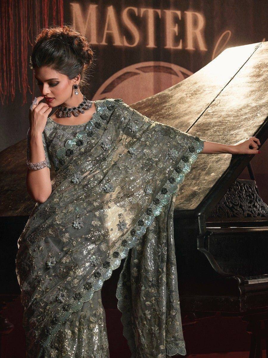 Elegant sequined saree with floral embroidery, styled for festive occasions, paired with statement jewelry.