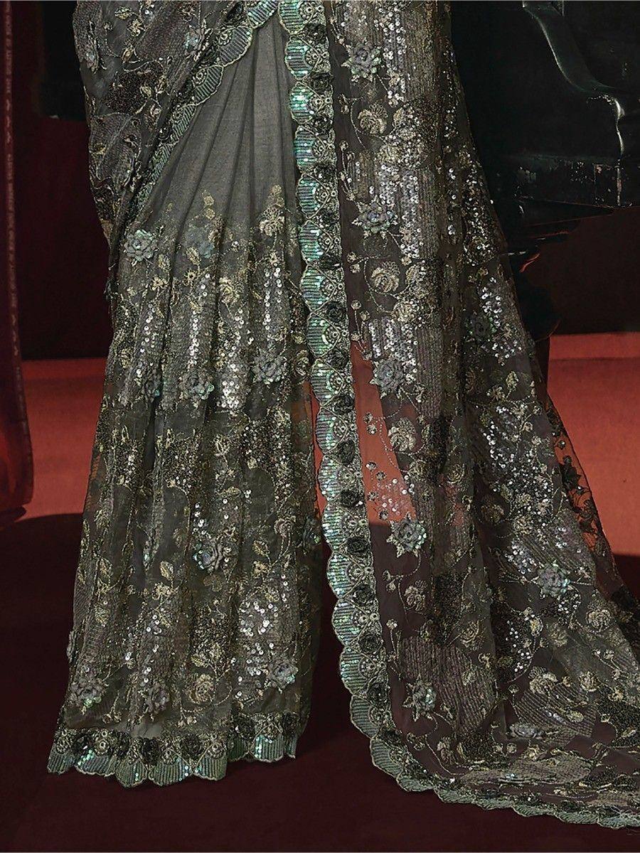 Dark green embroidered saree with sequins and floral lace border, elegant Indian ethnic wear