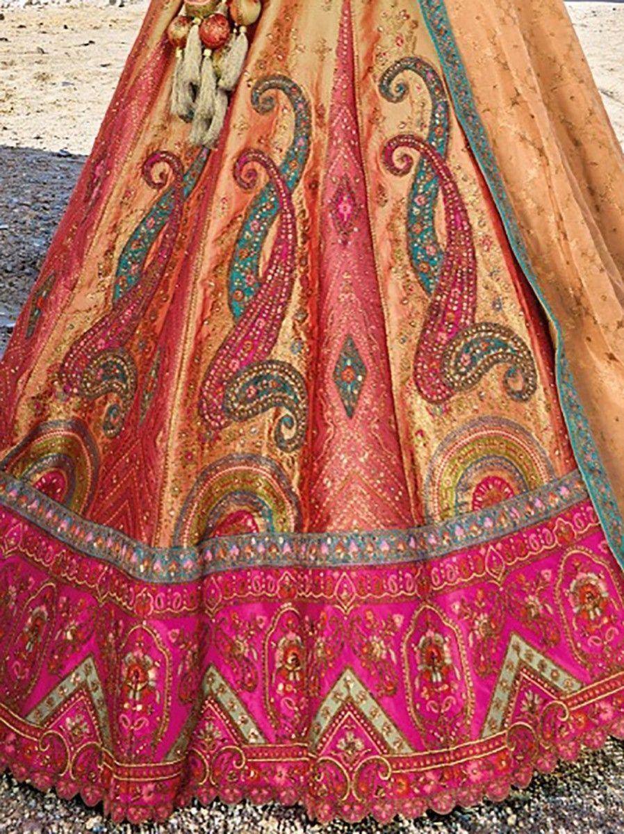 Designer lehenga choli with intricate paisley embroidery in pink and gold, perfect for Indian ethnic wear.