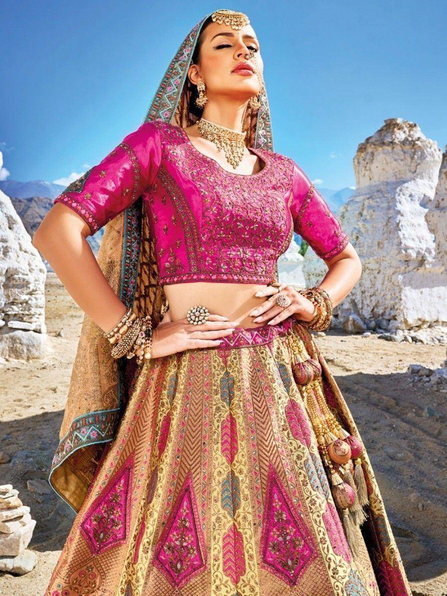 Pink and gold embroidered lehenga choli with dupatta, perfect for Indian weddings and festive occasions.