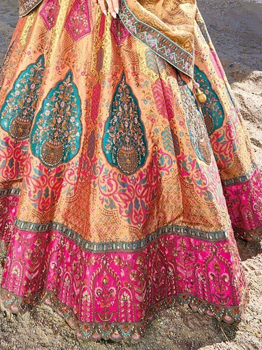 Designer lehenga choli with intricate paisley embroidery in pink, gold, and teal, perfect for Indian ethnic wear.
