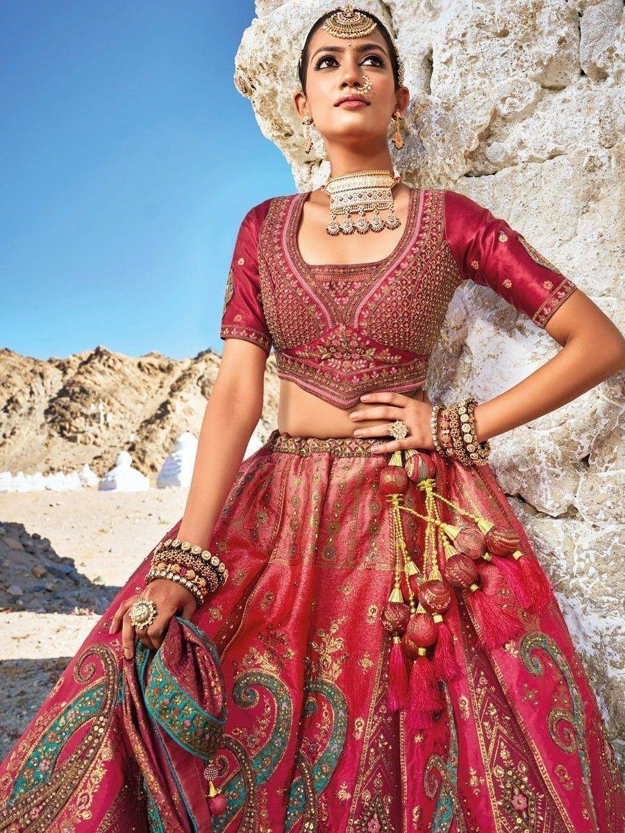 Red embroidered lehenga choli with gold detailing, traditional Indian bridal wear, desert backdrop