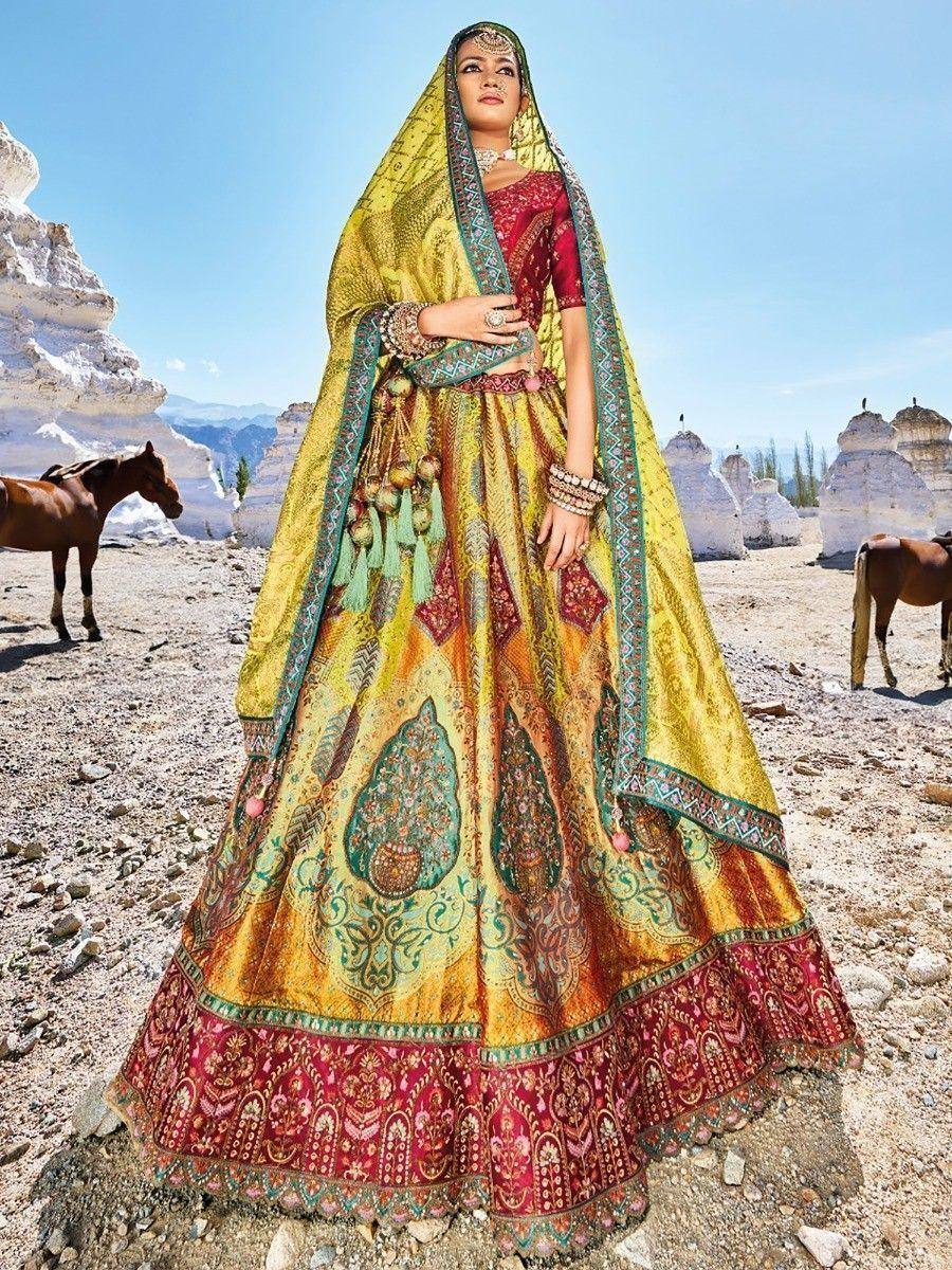 Yellow and red designer lehenga choli with intricate embroidery, perfect for Indian weddings and festive occasions.