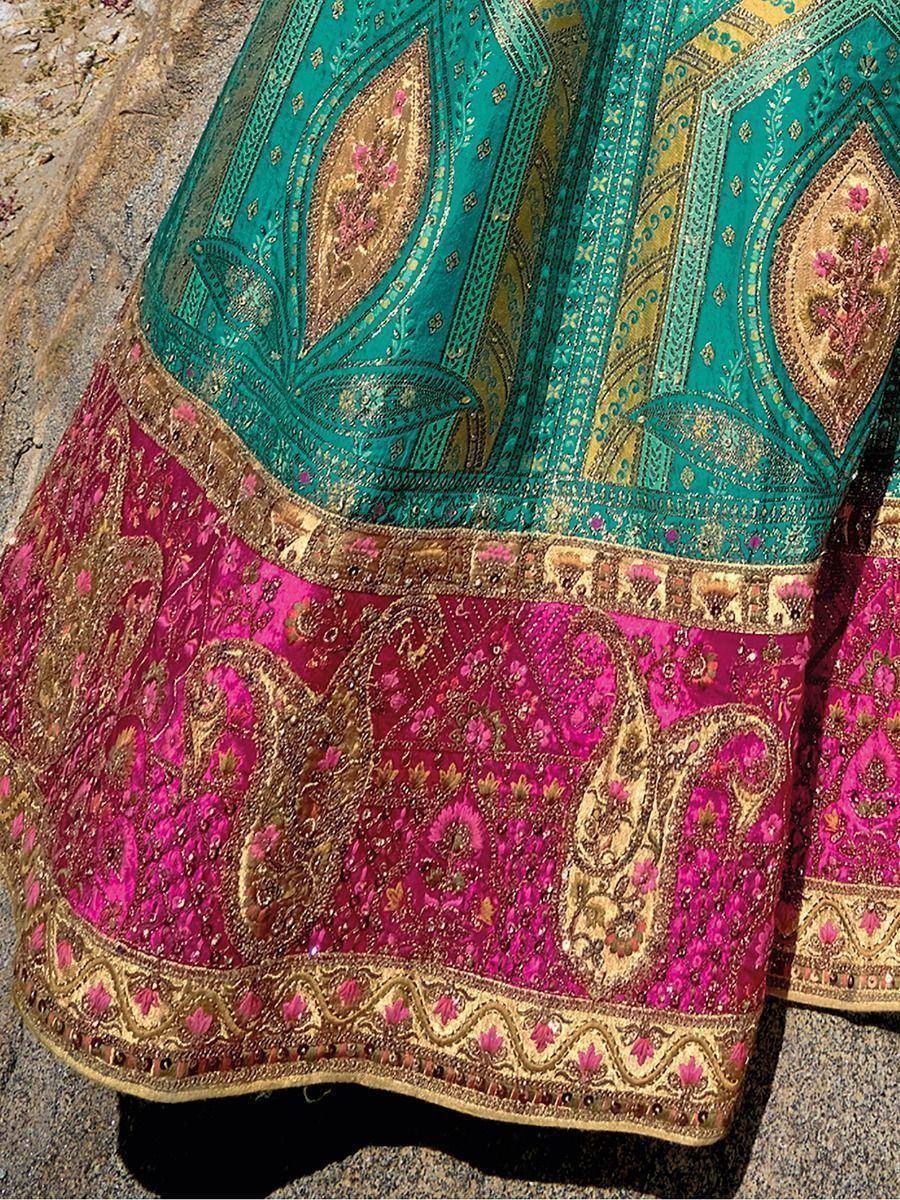 Teal and magenta ethnic lehenga with gold paisley embroidery and intricate border detailing