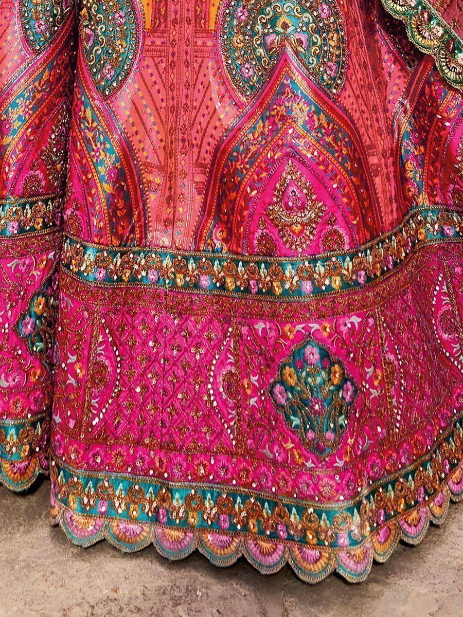 Vibrant pink ethnic lehenga with intricate gold and turquoise embroidery, perfect for Indian weddings and festive occasions.