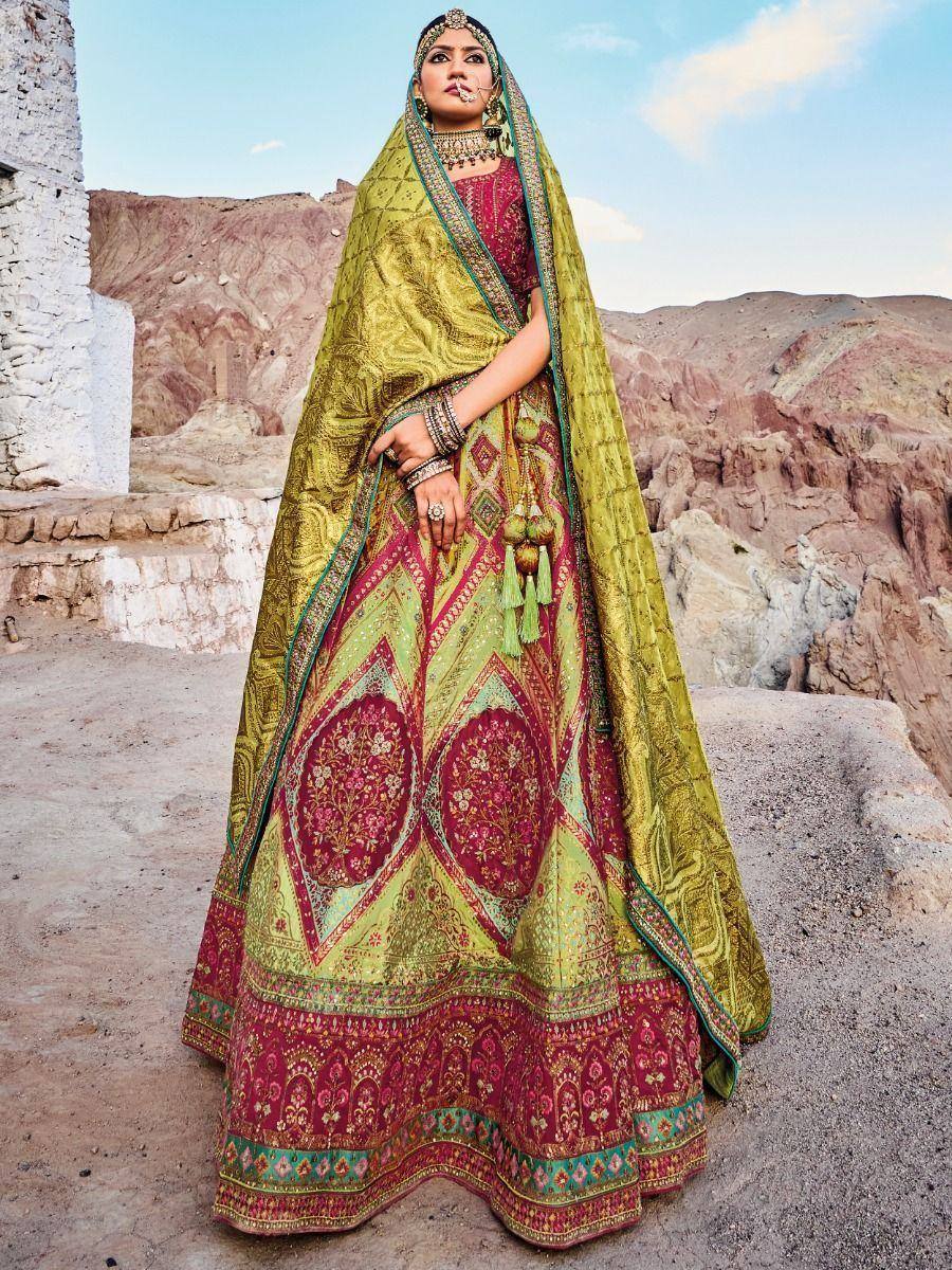 Woman in designer lehenga choli with intricate embroidery, green dupatta, desert backdrop