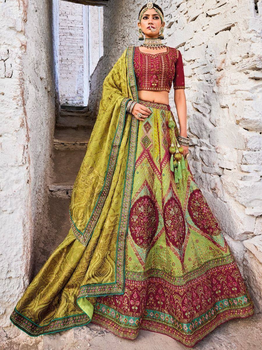 Designer lehenga choli in green and maroon with intricate embroidery, perfect for Indian ethnic wear occasions.