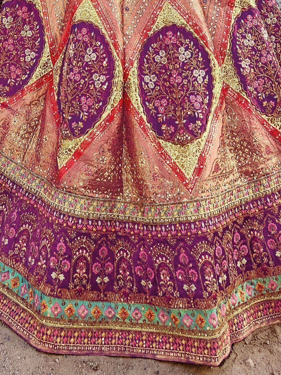 Designer lehenga choli with intricate floral embroidery and vibrant purple, gold, and pink hues