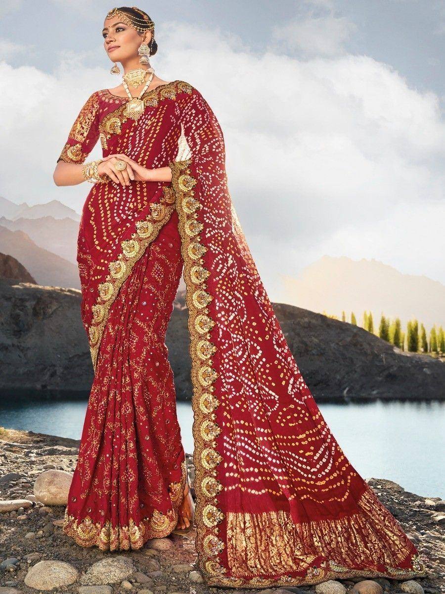 Red and gold embroidered saree with heavy zari work, perfect for Indian weddings and festive occasions