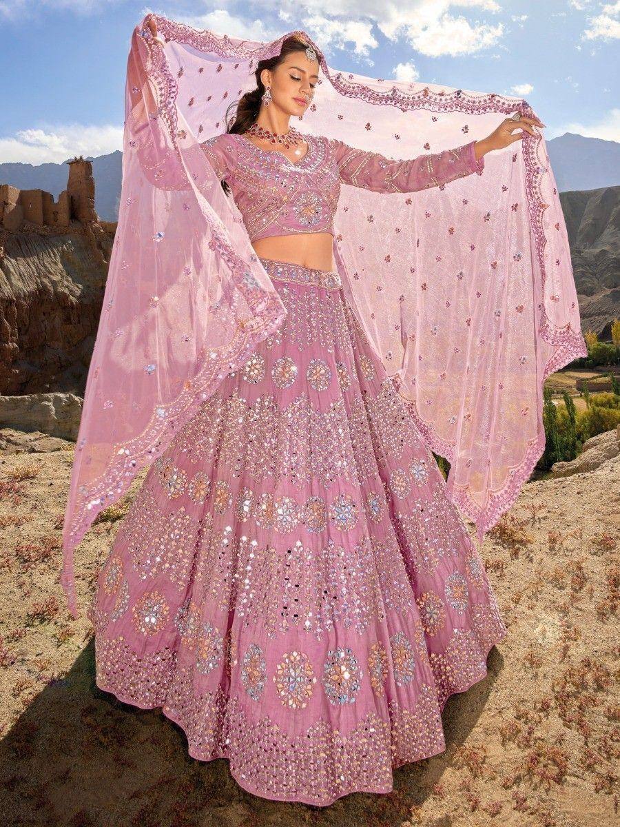 Pink designer lehenga choli with heavy embroidery and dupatta, perfect for Indian weddings and festive occasions.