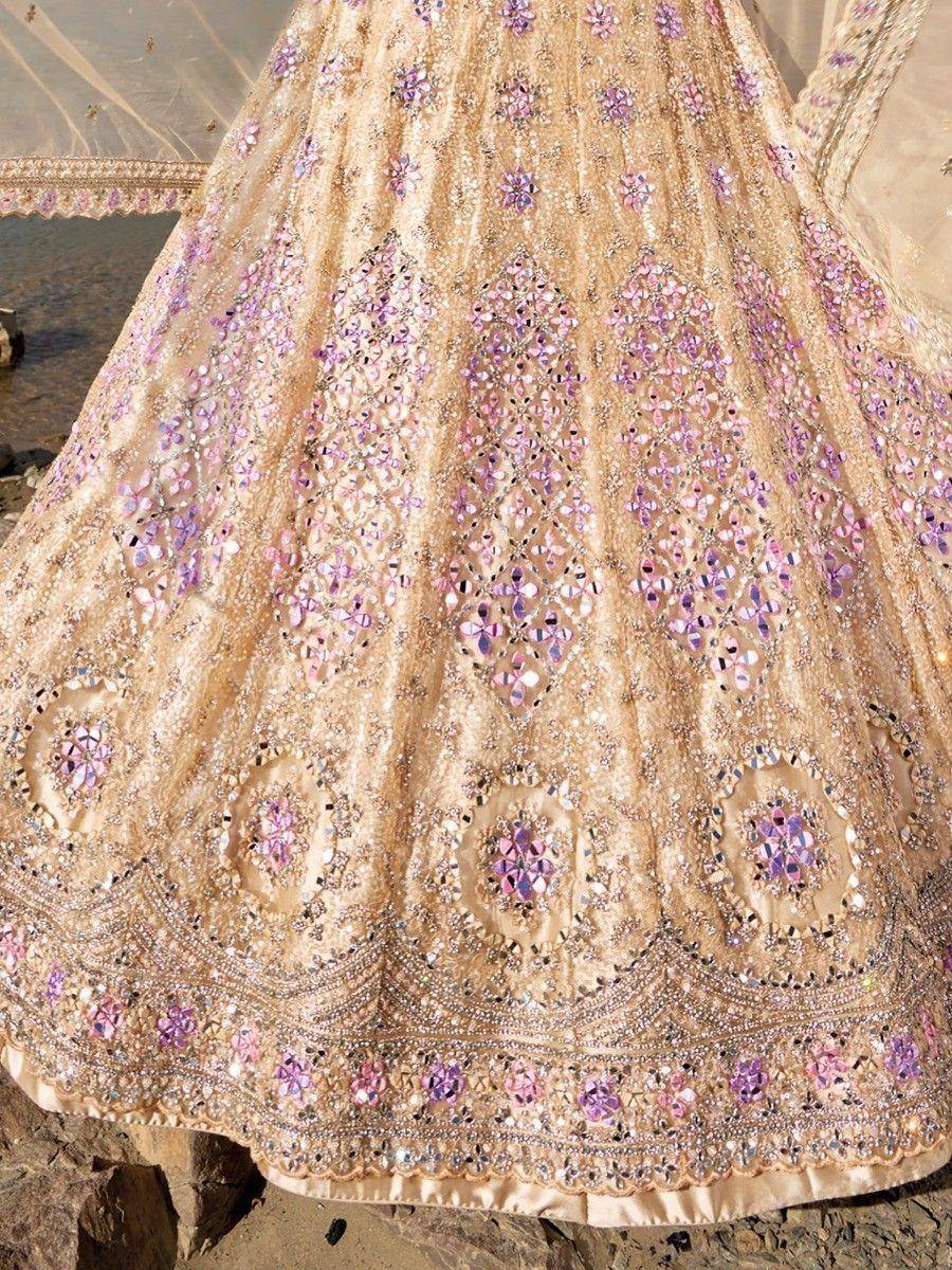 Gold lehenga with pink mirror work and floral embroidery, perfect for Indian weddings and ethnic events