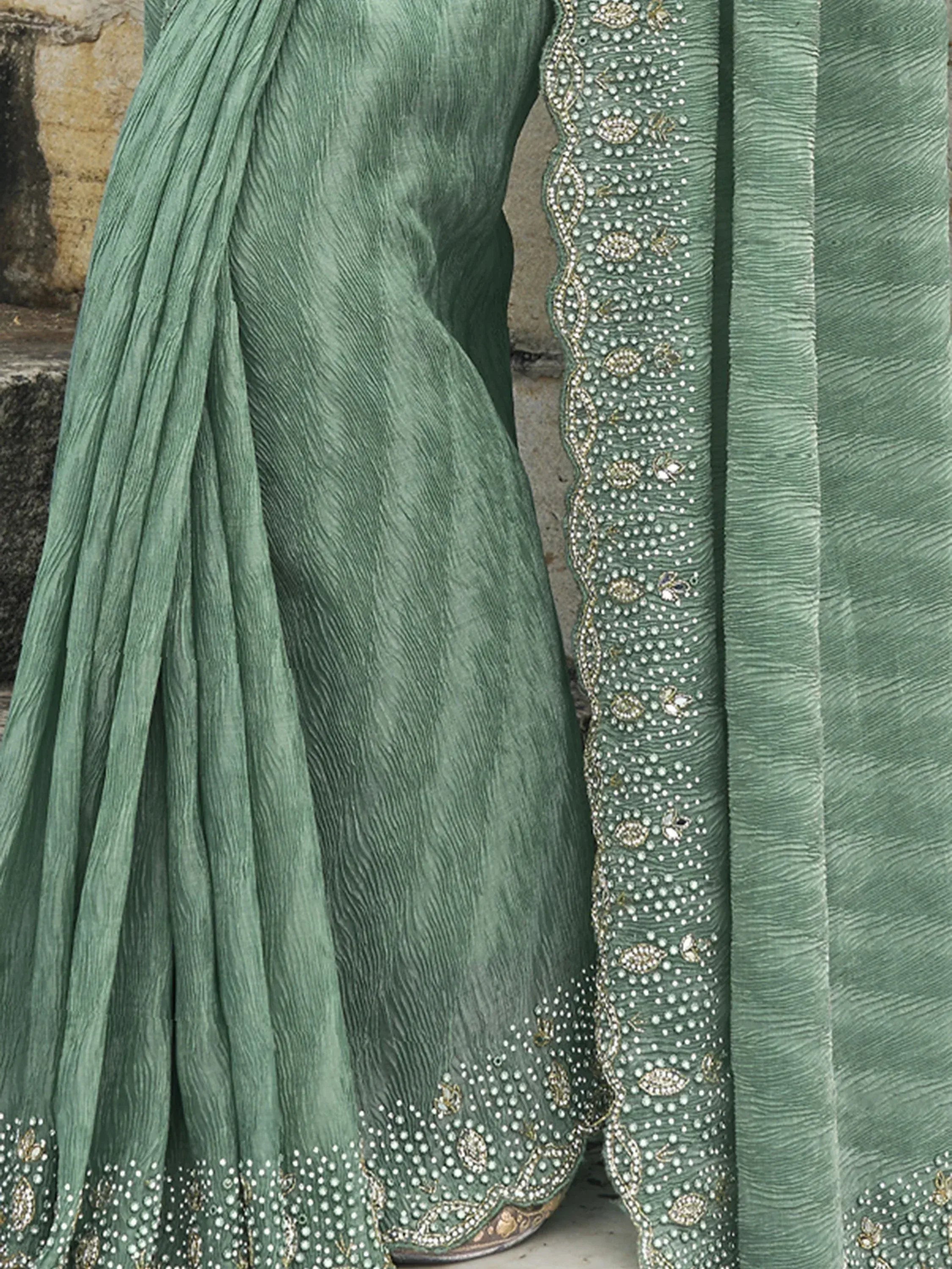 Green ethnic saree with intricate bead and sequin embroidery, perfect for Indian occasions.
