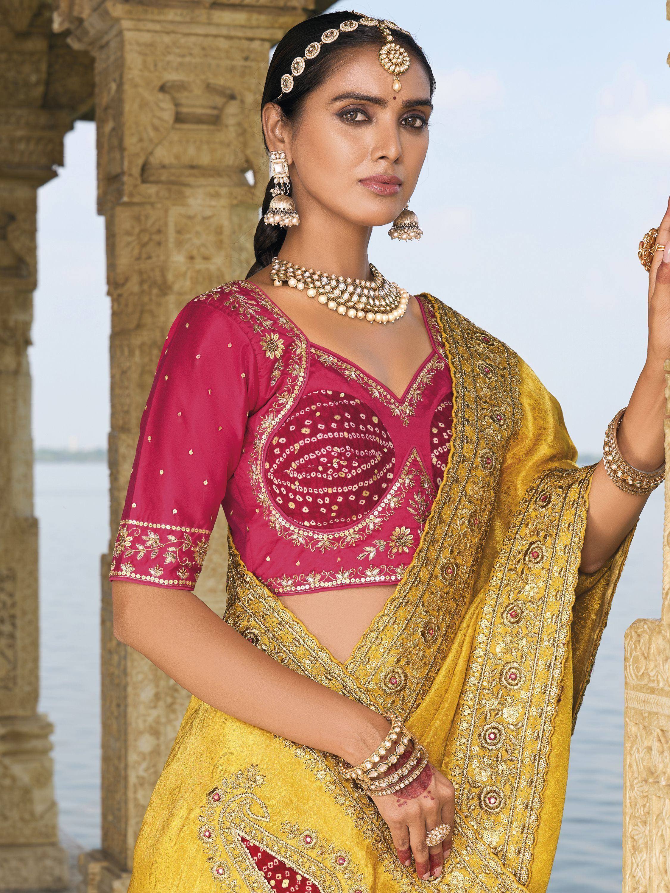 Elegant Indian ethnic wear: pink embroidered blouse with golden saree, traditional jewelry, perfect for festive occasions.